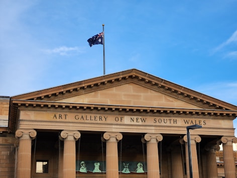 a building with pillars and a flag on top of it