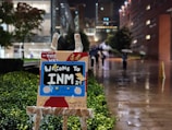 a cardboard sign that says welcome to inn 2