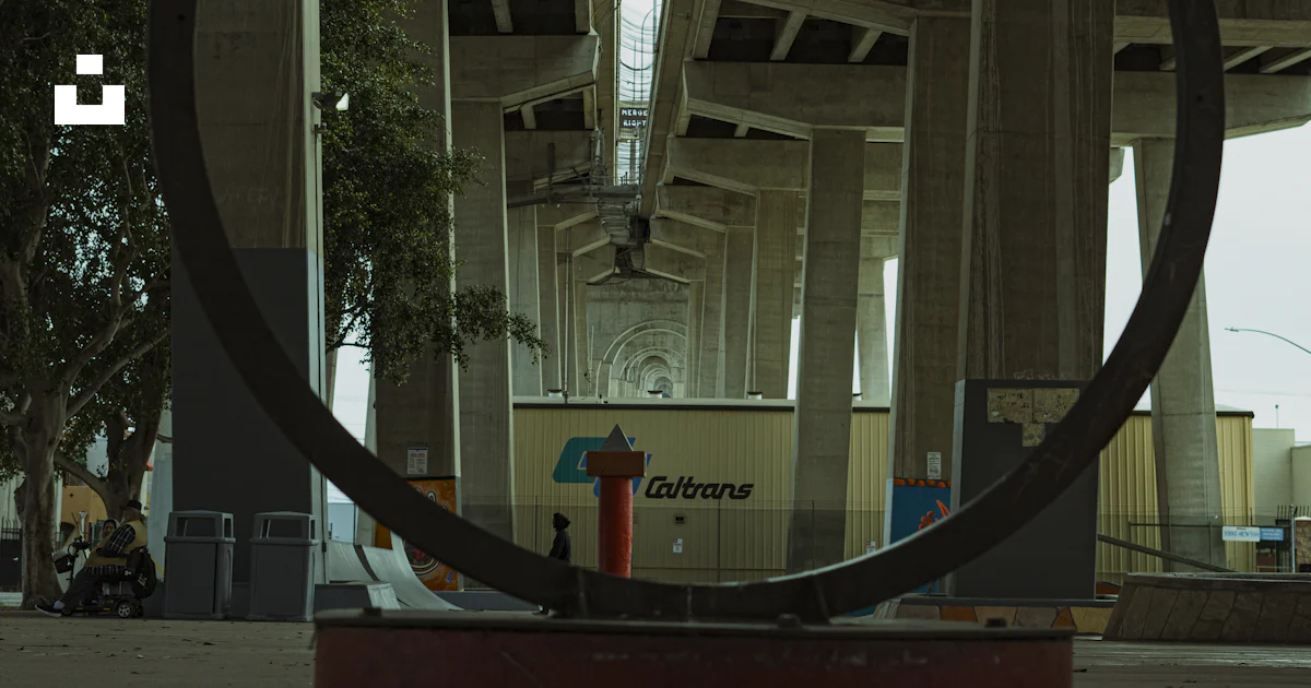 Object Under Bridge A large metal object on the ground under a bridge photo – Free Coronado ...