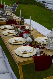 a long table set up with place settings and place settings
