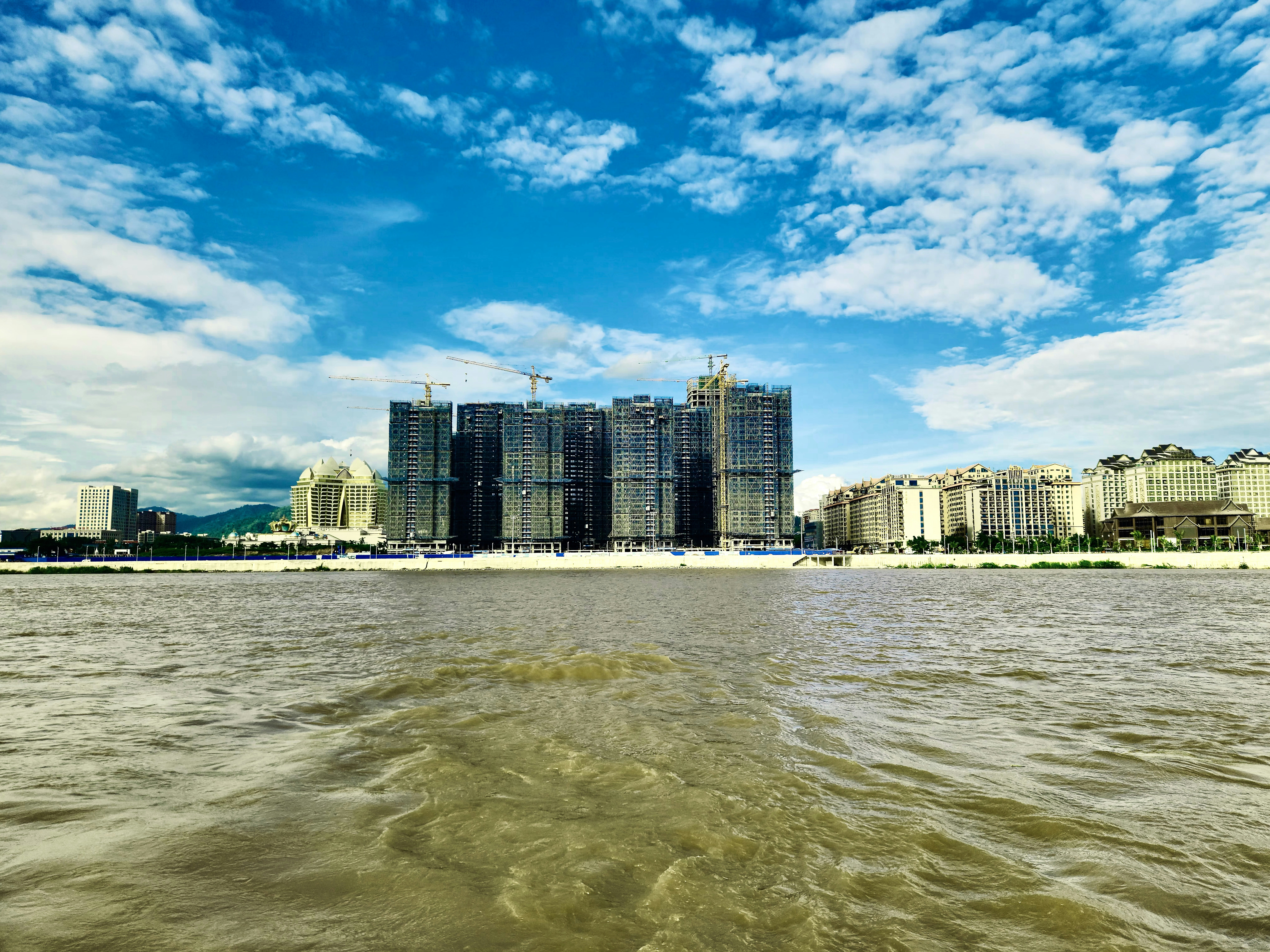 a body of water with buildings in the background