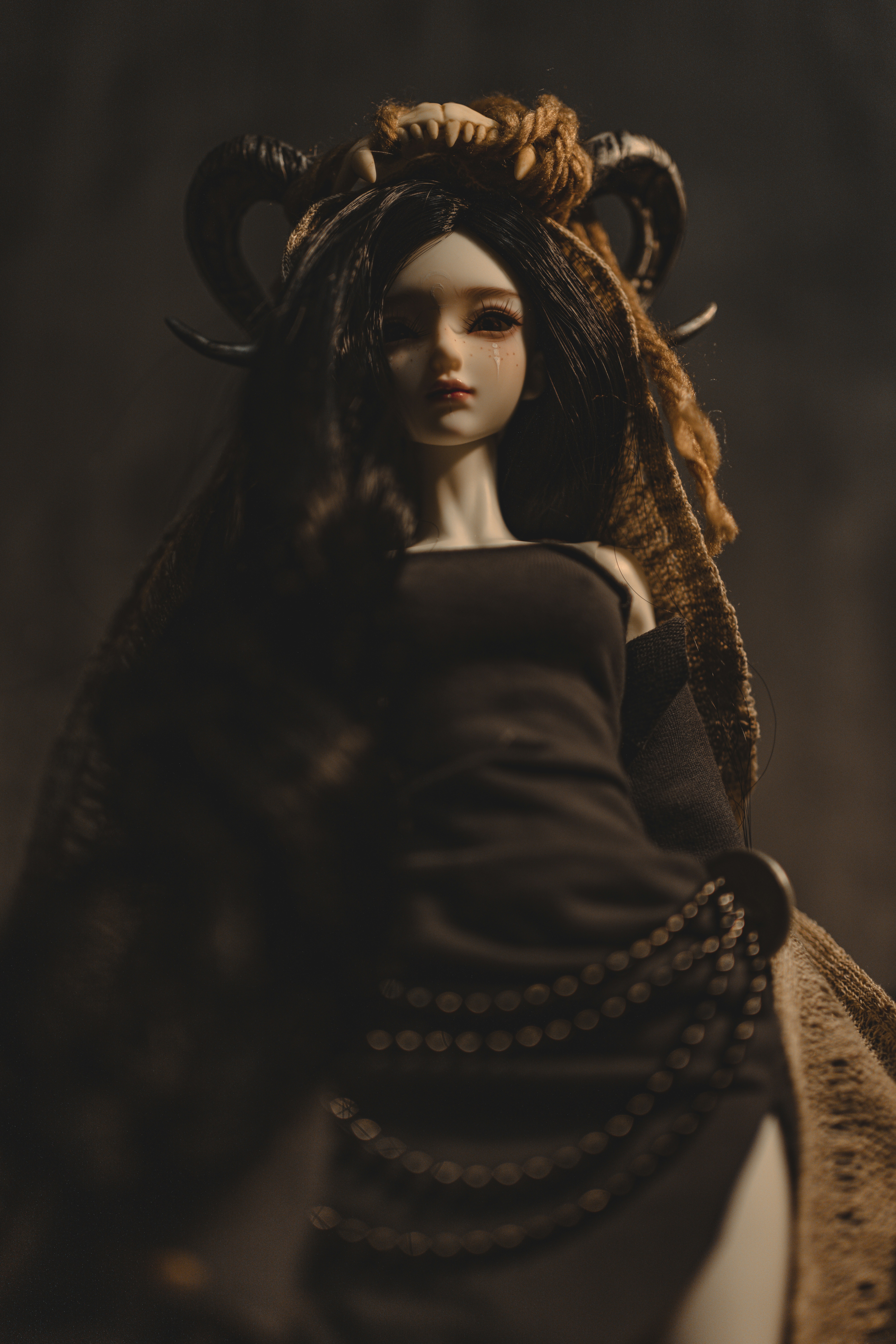 a doll with horns and a black dress