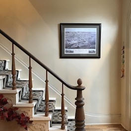 a staircase with a picture hanging on the wall