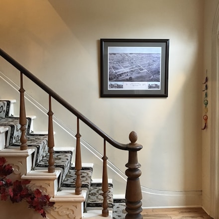 a staircase with a picture hanging on the wall