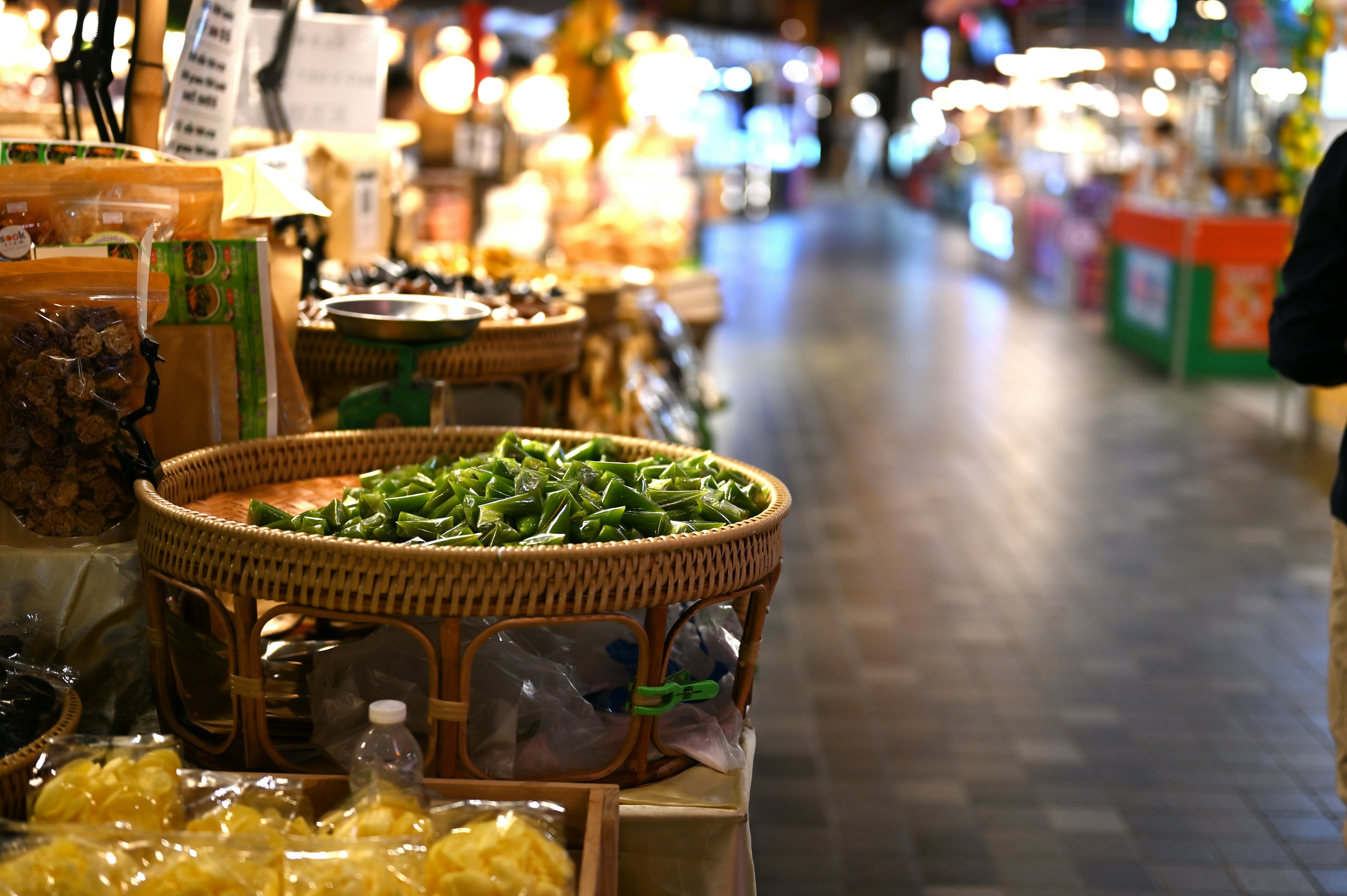a person standing in front of a store filled with produce