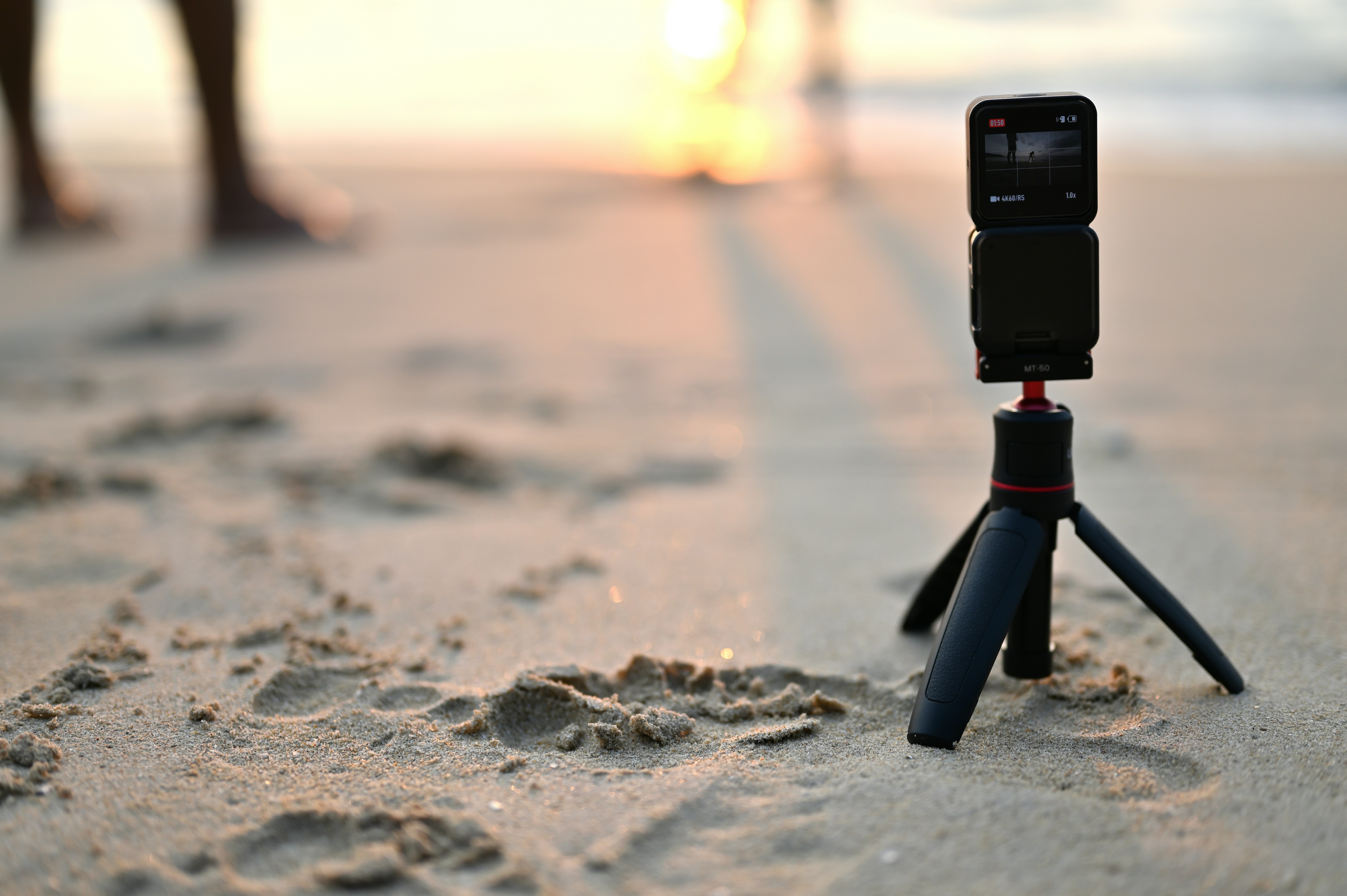 a tripod with a camera attached to it on a beach