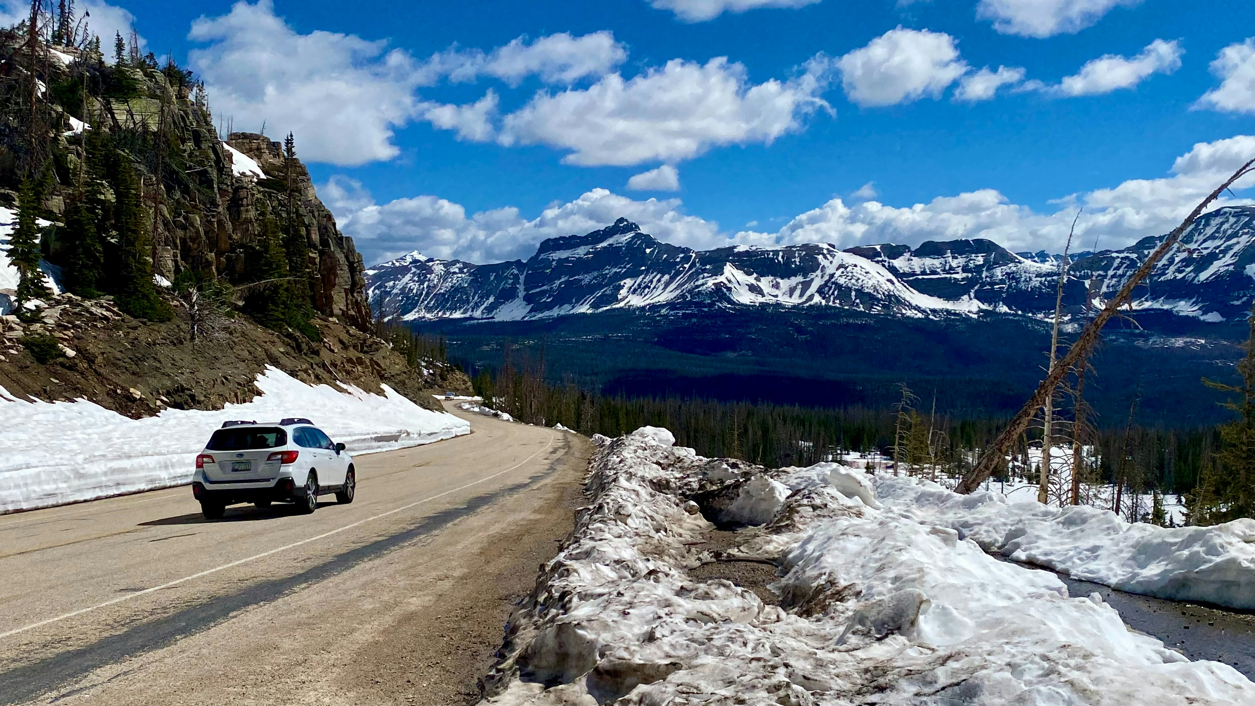 a car driving down a road in the mountains