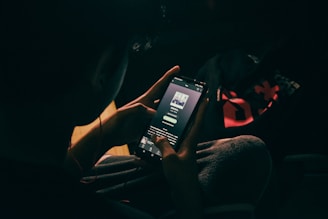a person holding a cell phone in their hand