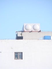 a white building with two white round objects on top of it