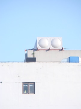 a white building with two white round objects on top of it