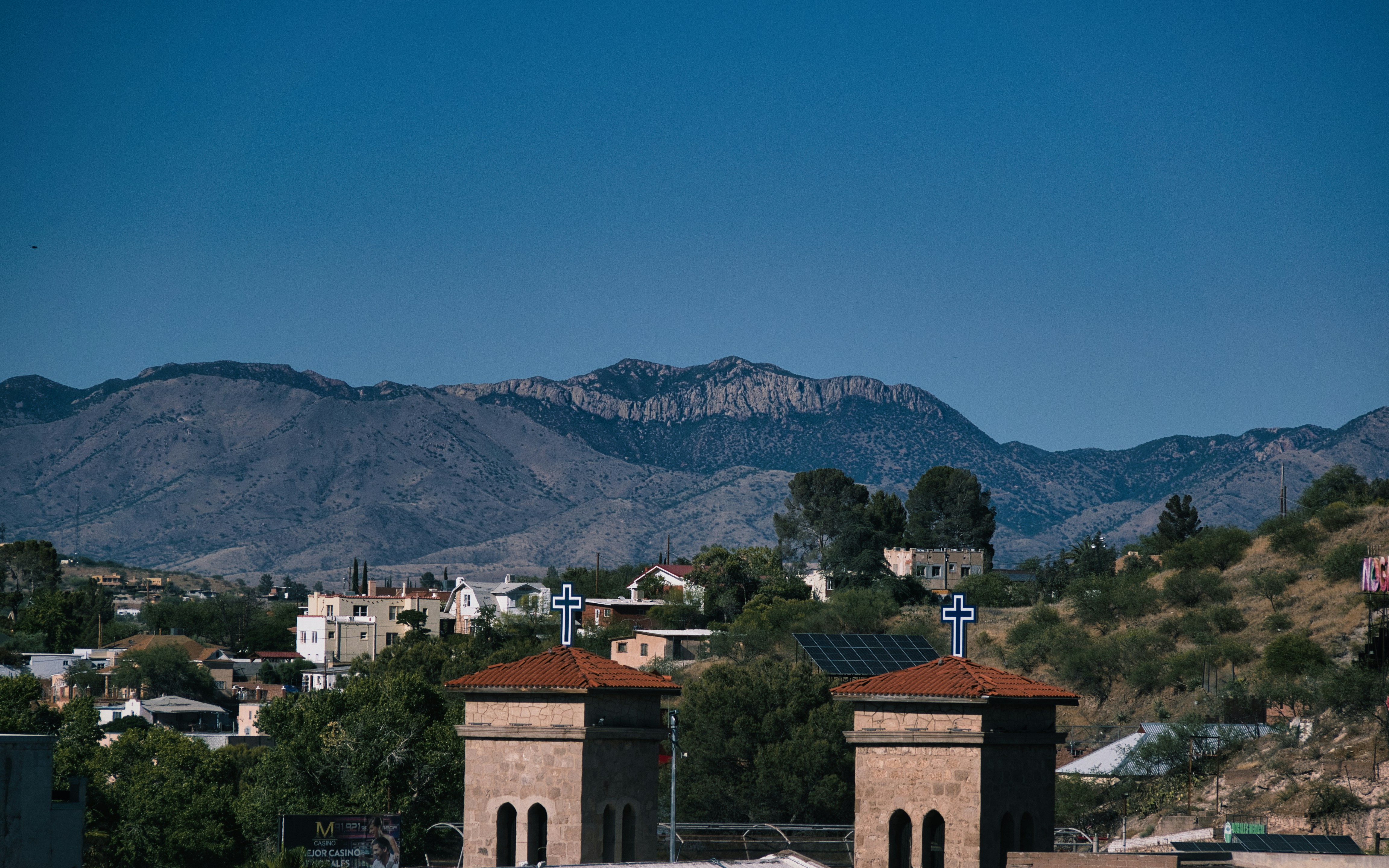 a couple of buildings with a mountain in the background