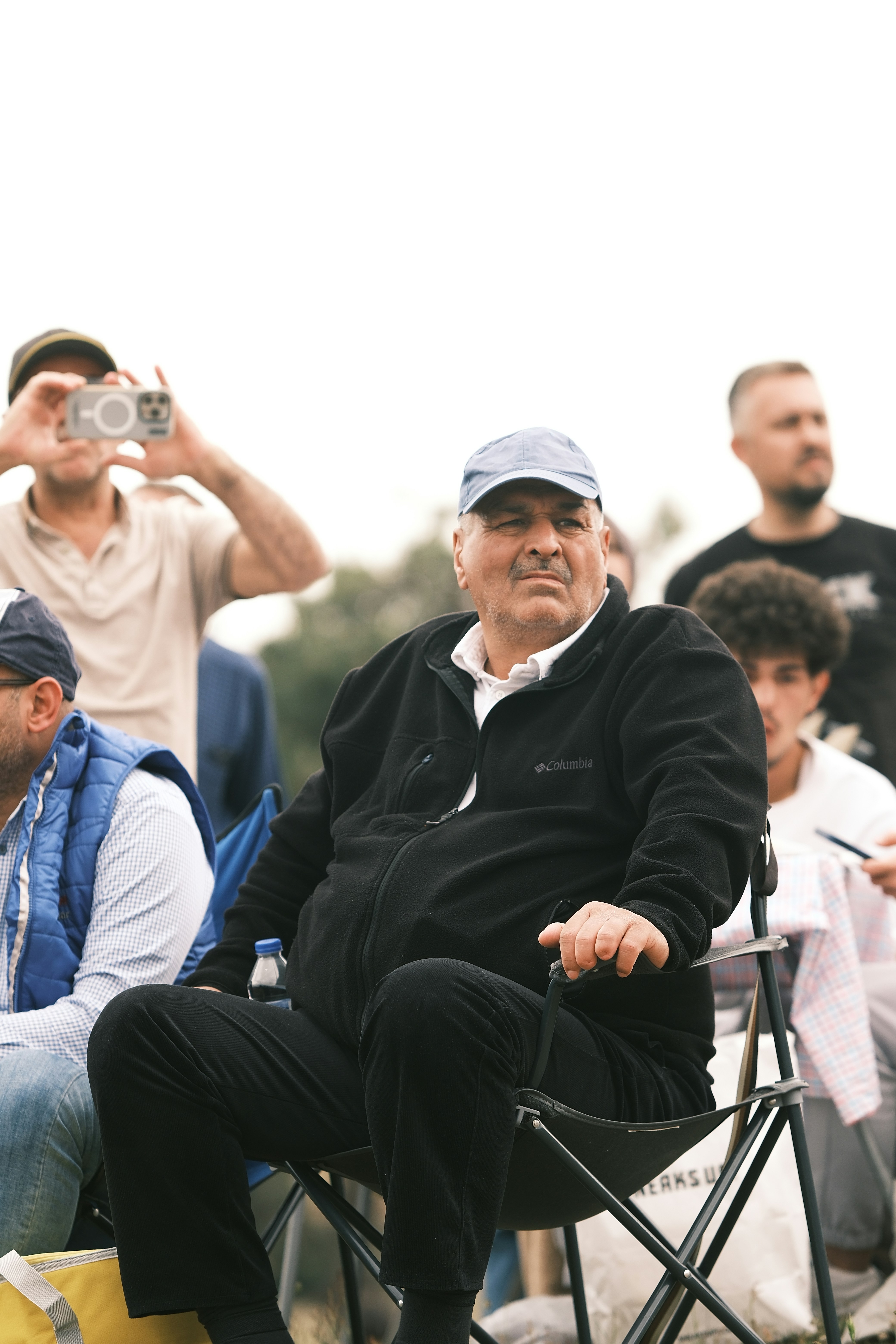 A group of people sitting around each other