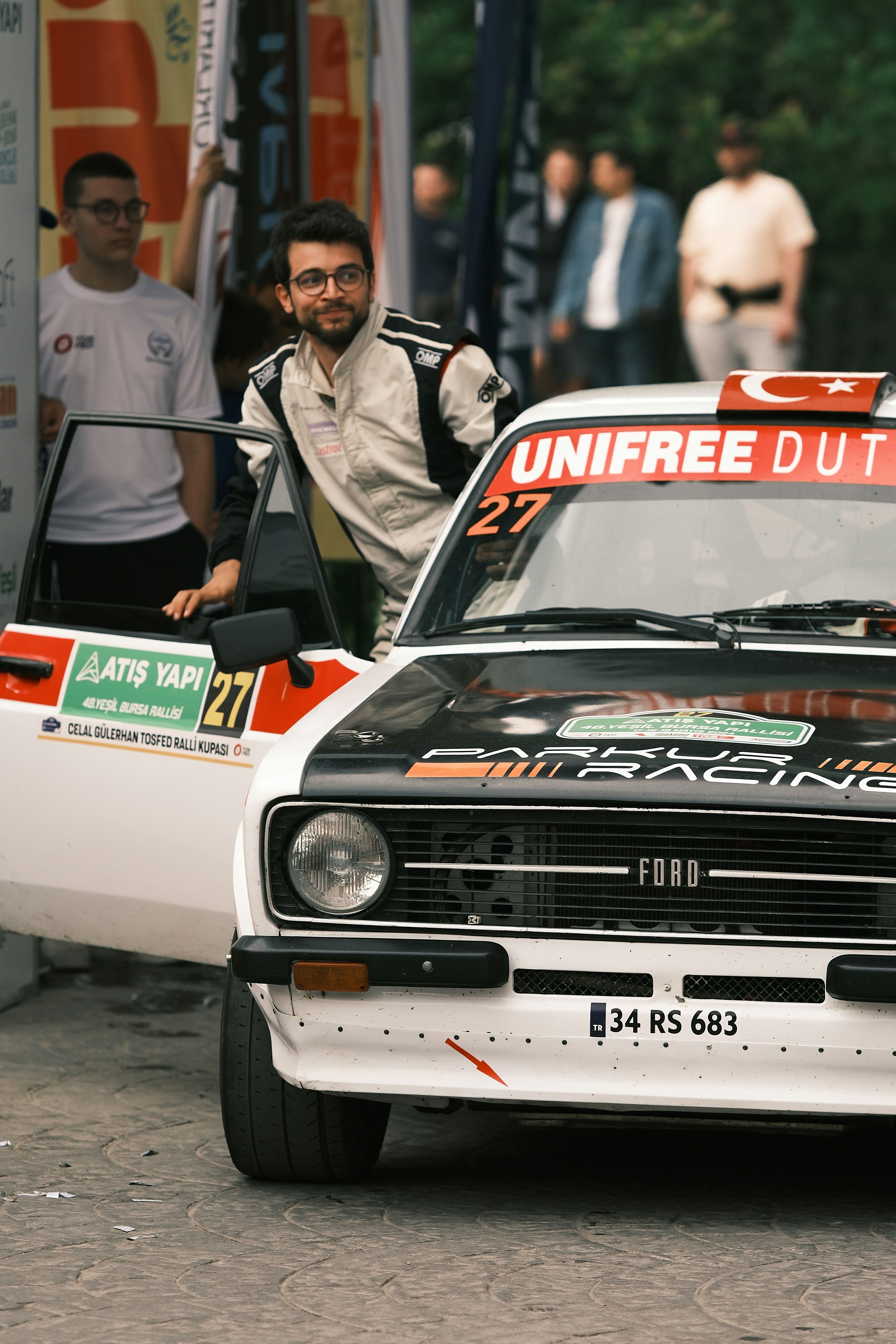 A man driving a race car down a street