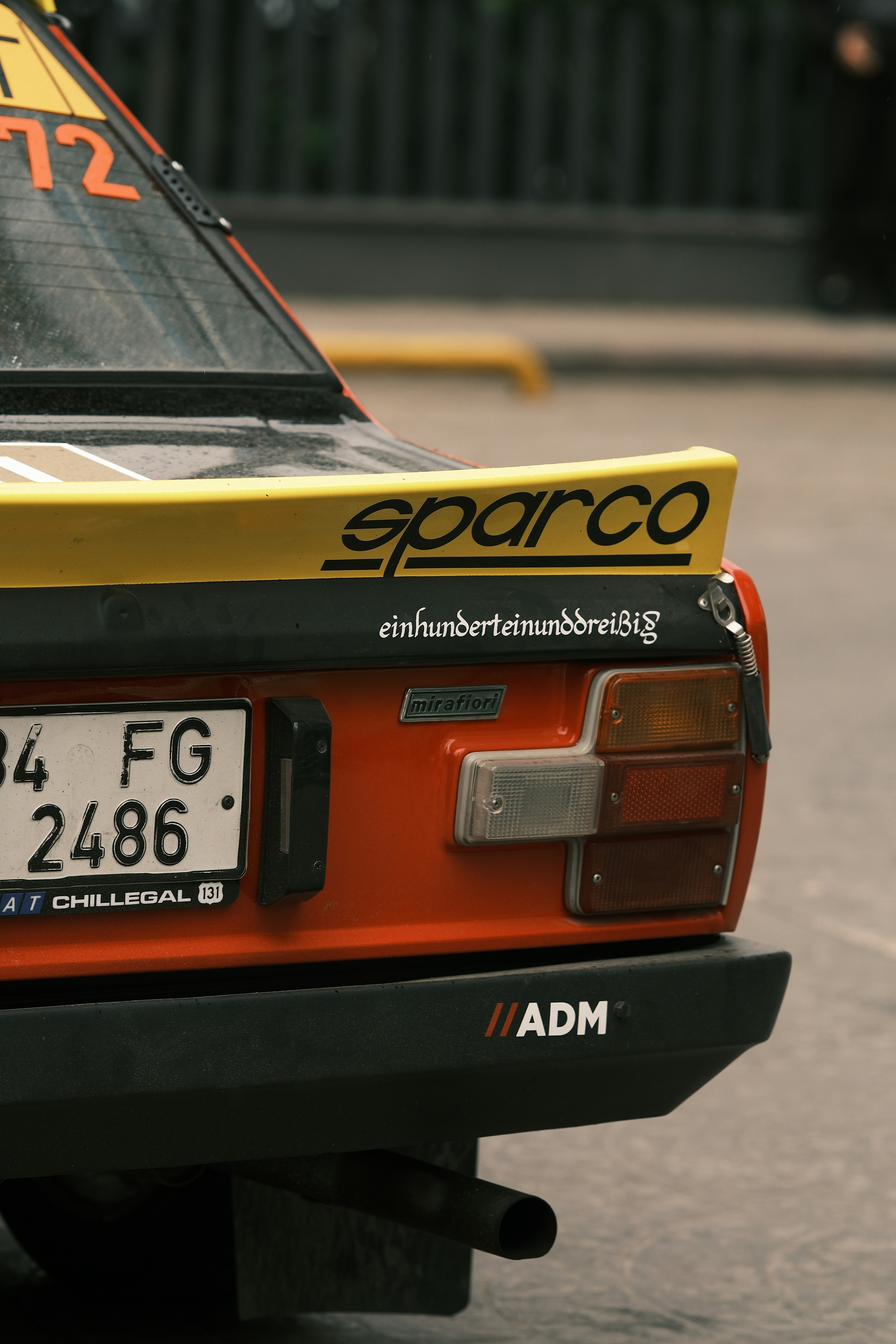 An orange and yellow sports car parked in a parking lot