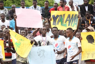 a group of people holding up signs in front of a crowd