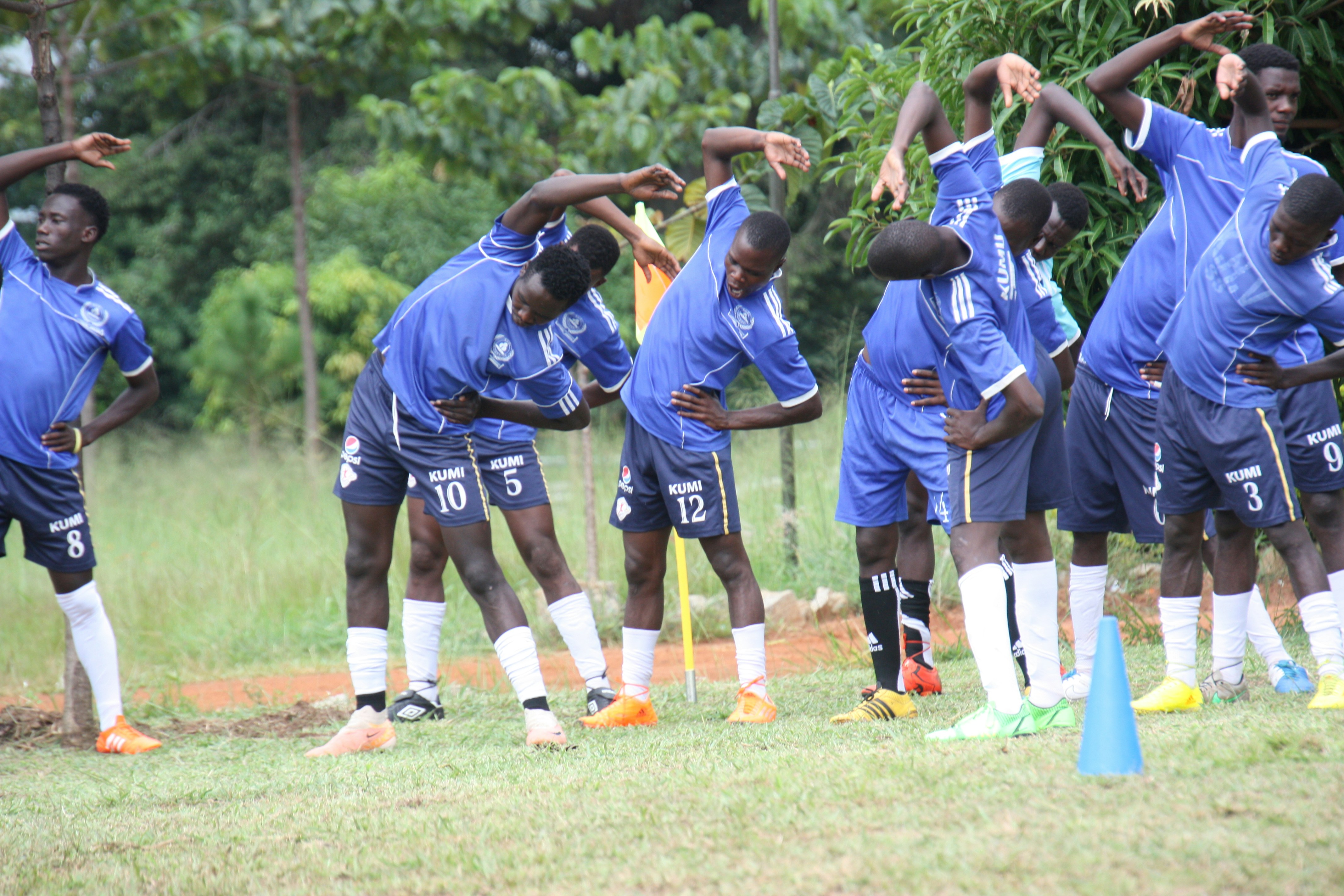 a group of young men standing next to each other on a field
