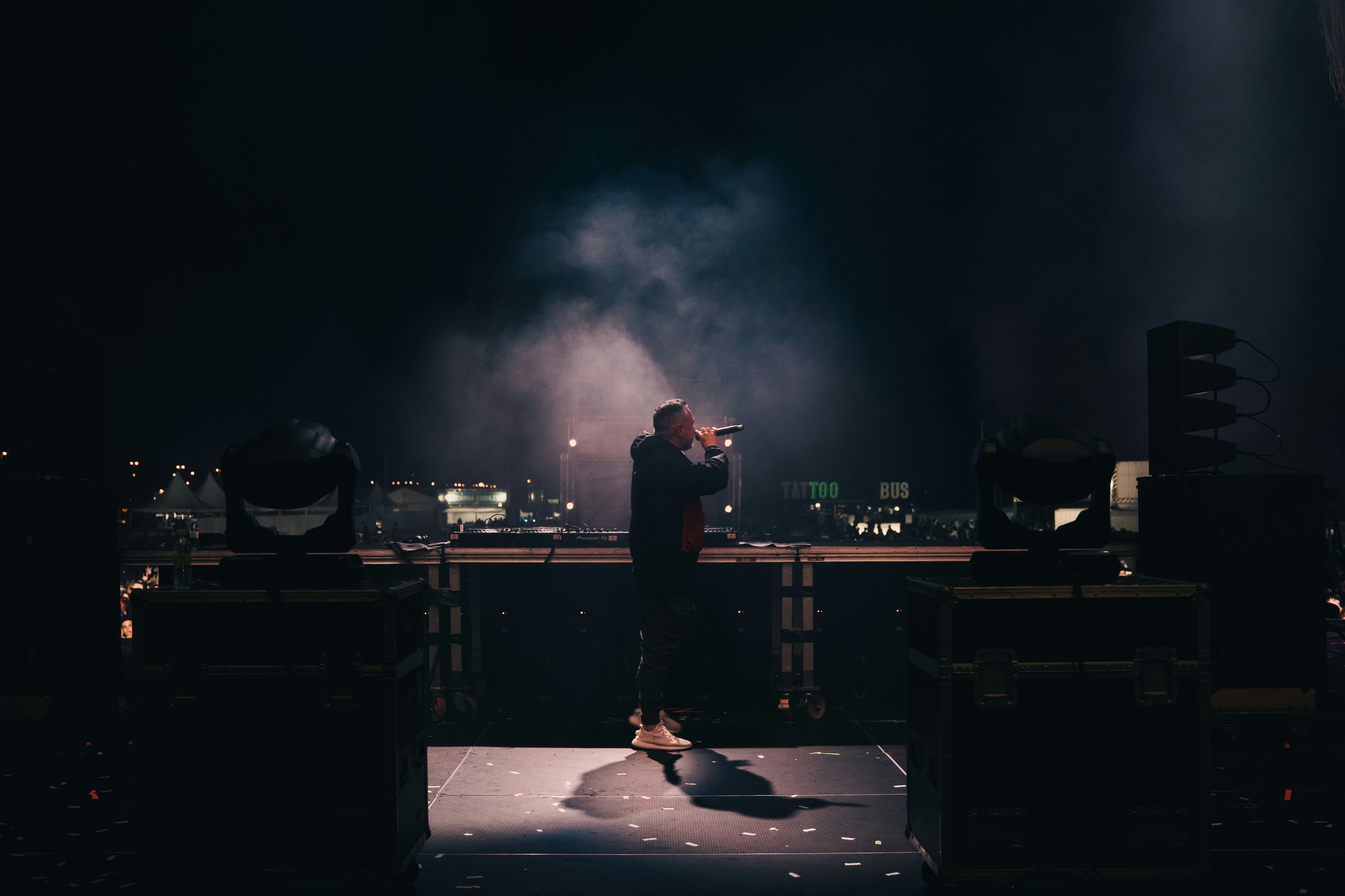 A person standing on a stage with a microphone