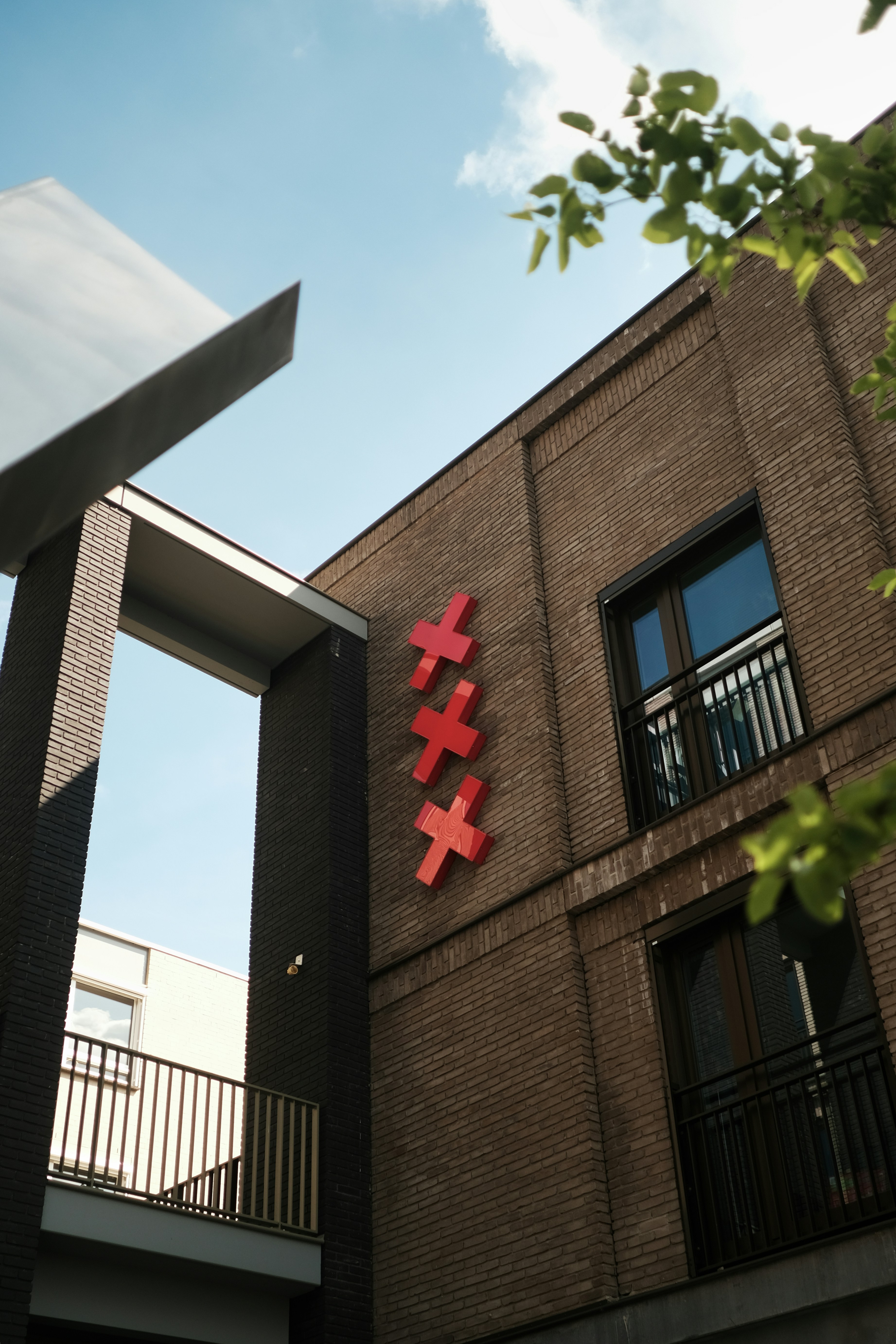 A tall building with a red cross on it's side