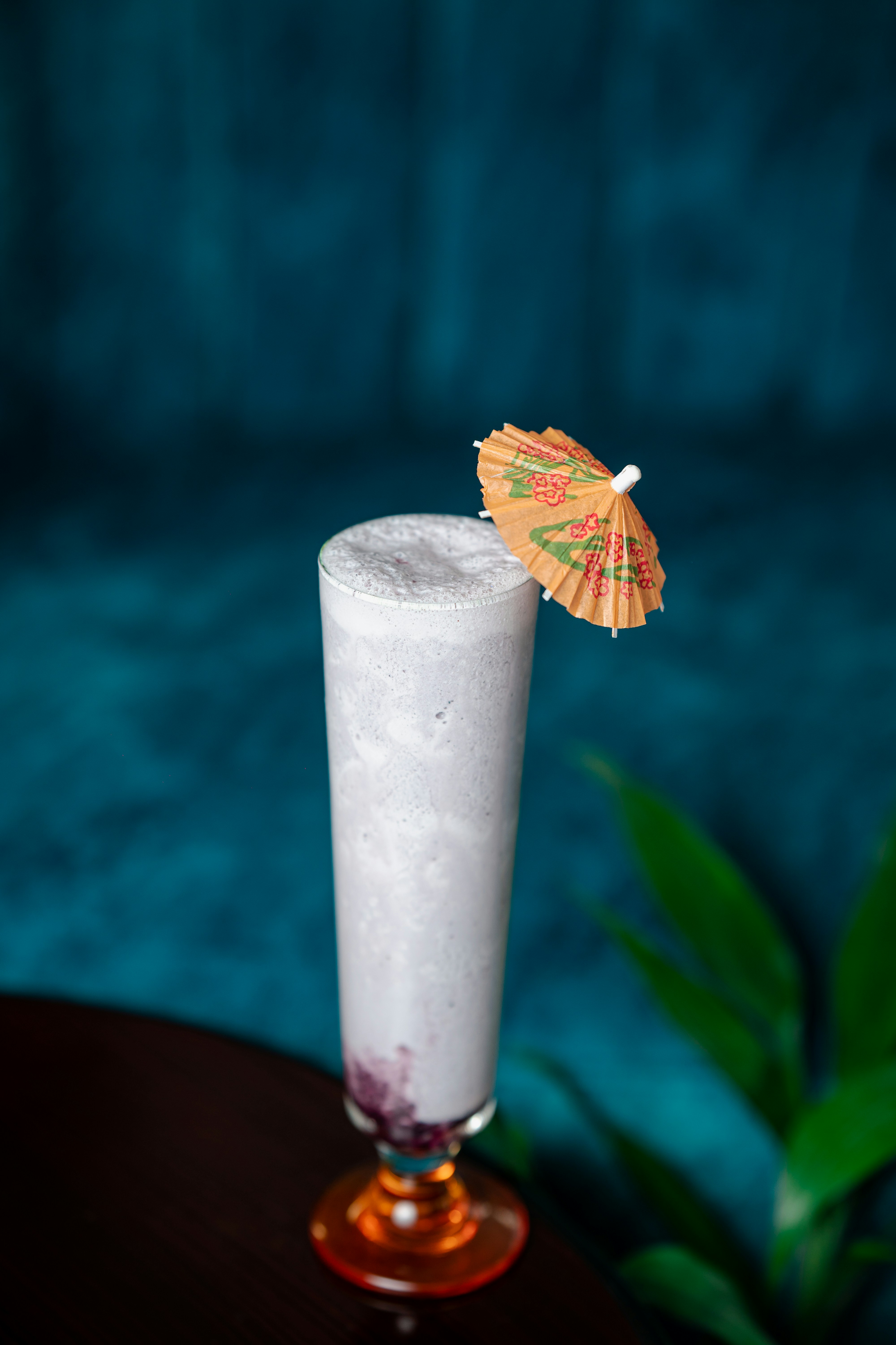 A drink with an umbrella on a table