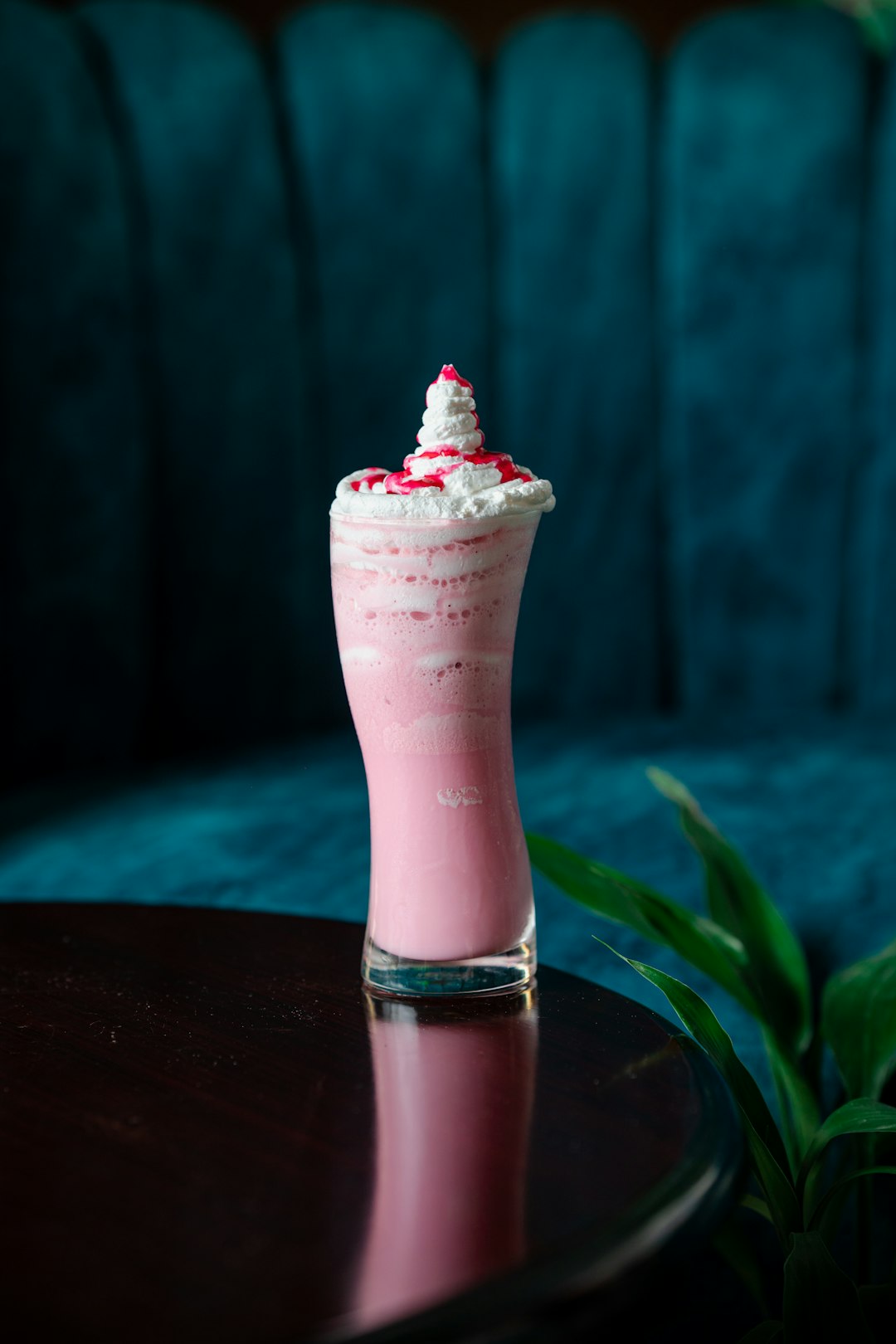 A pink drink sitting on top of a table