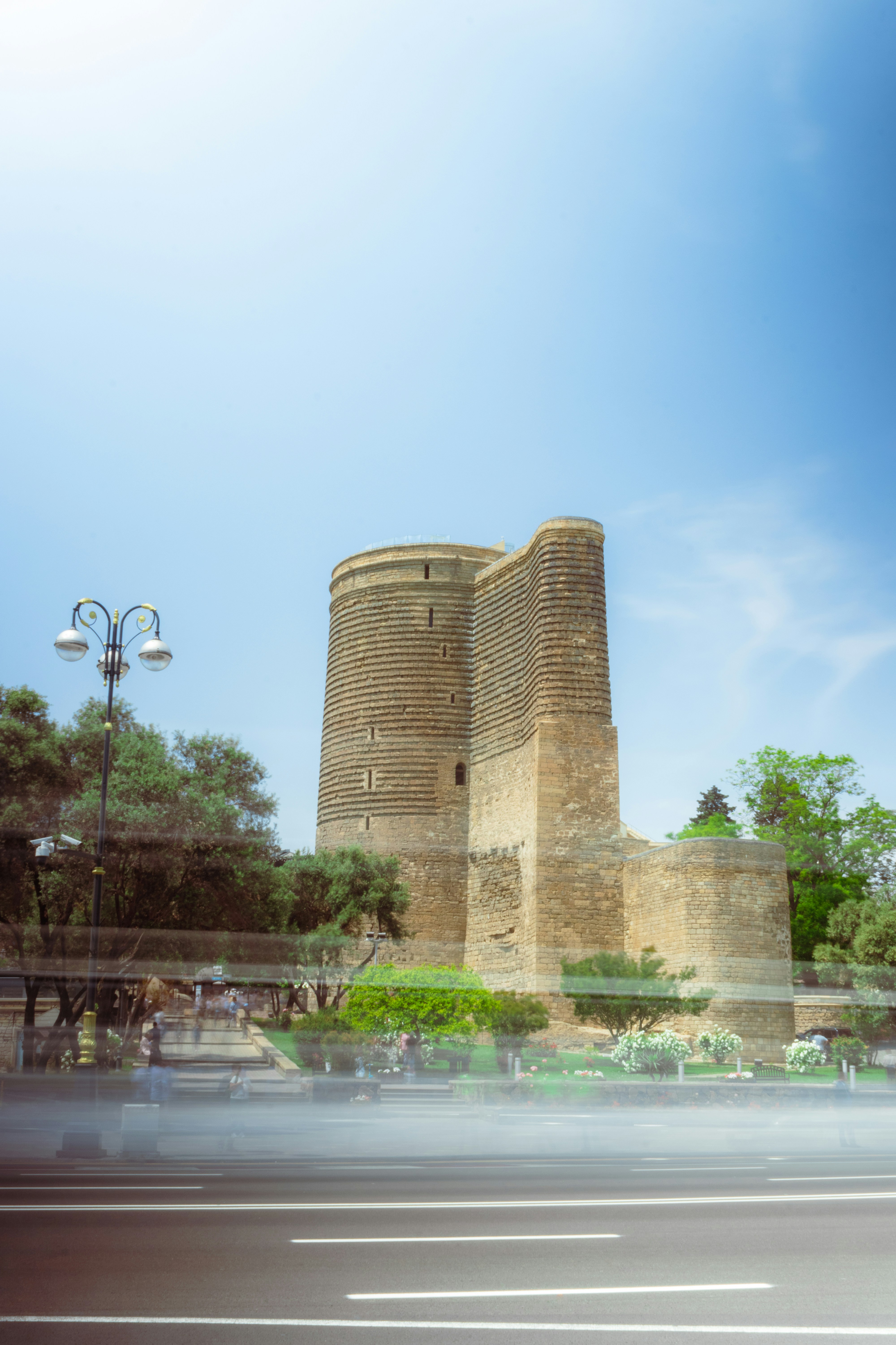 A very tall brick building sitting on the side of a road