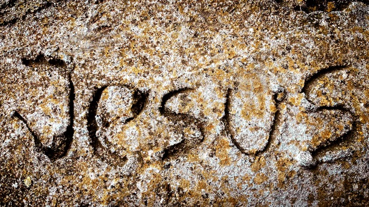 a close up of a rock with writing on it