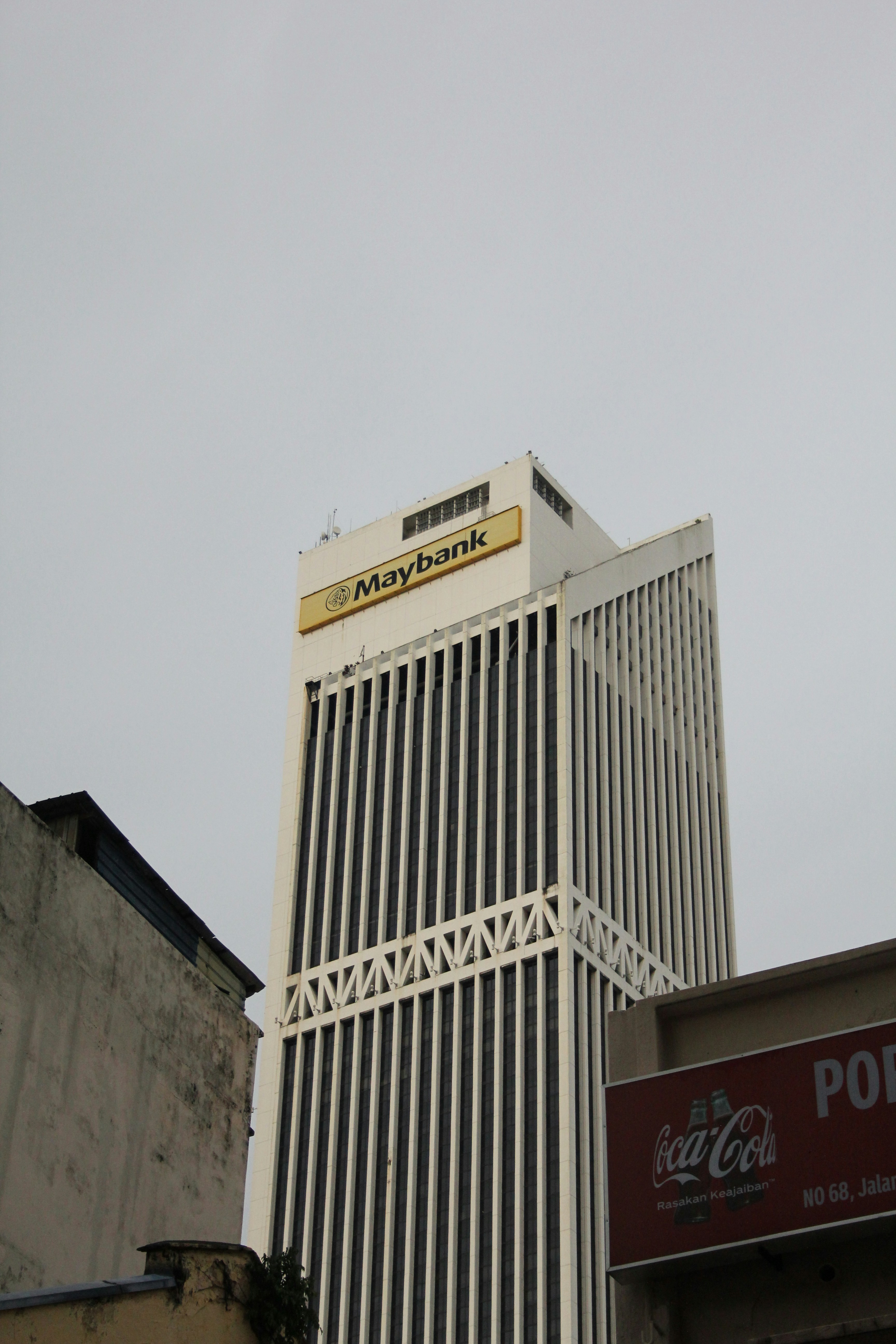 A tall building with a coca cola sign on top of it