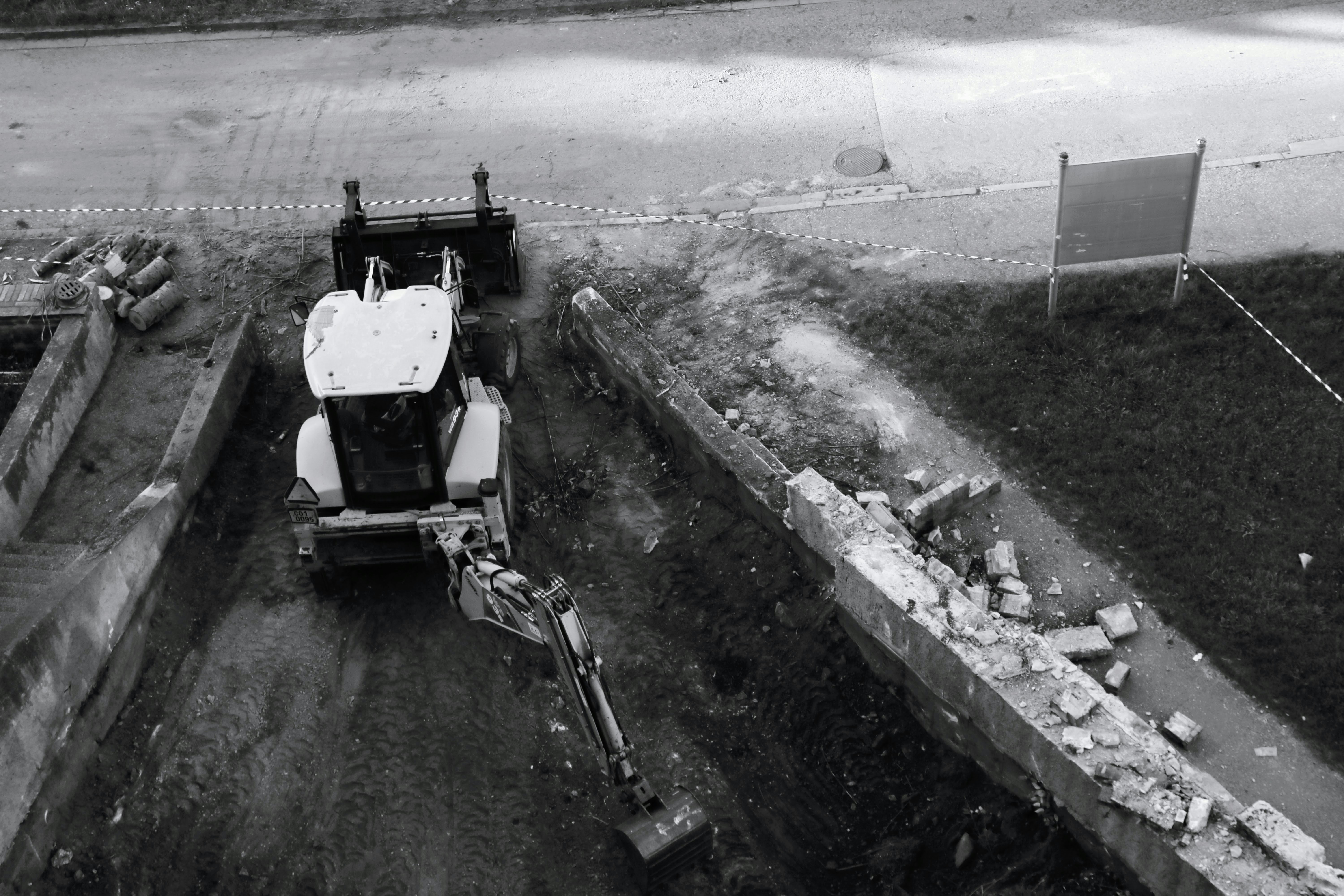 Construction demolition site with heavy machinery clearing debris, industrial cleanup operation