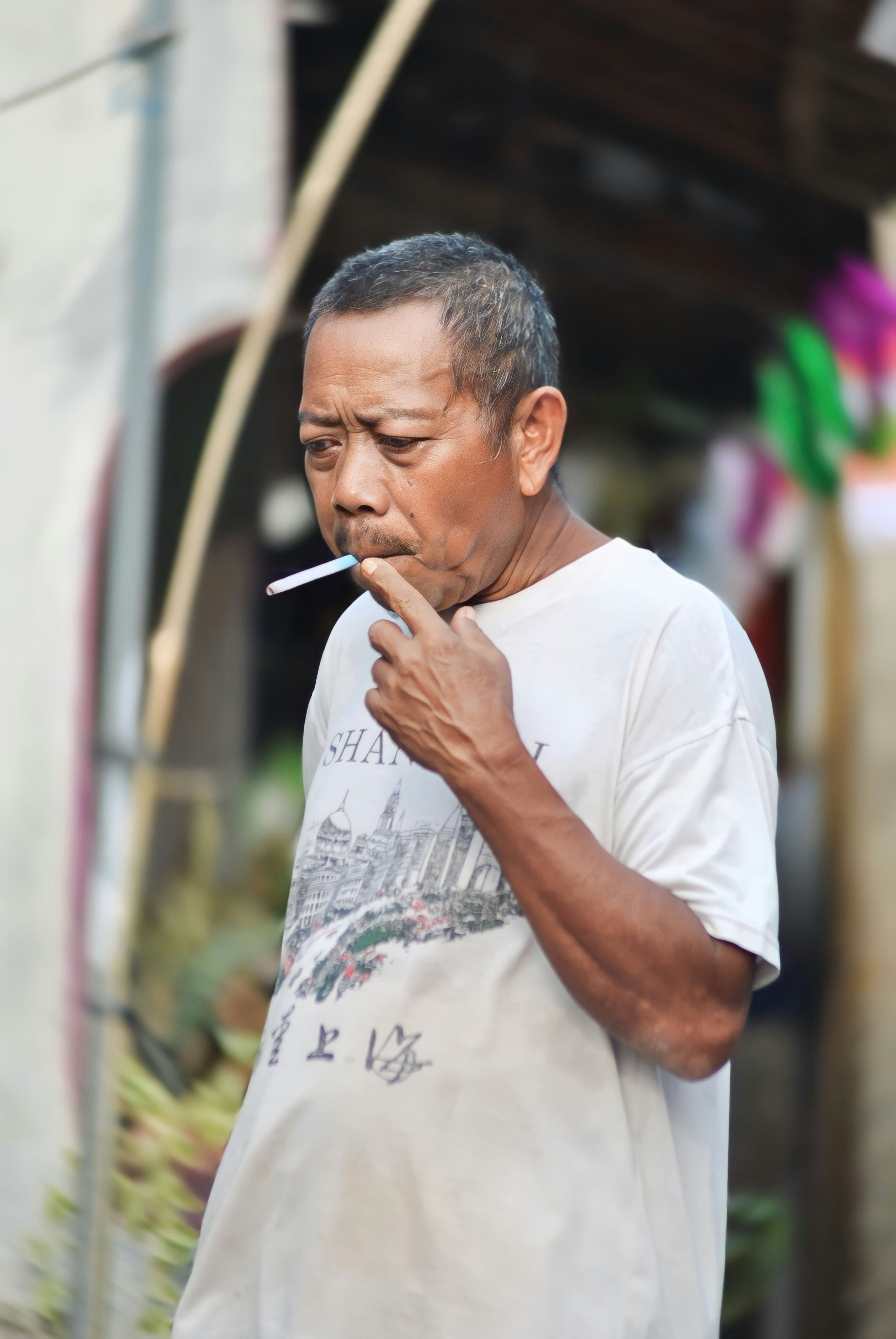 A man smoking a cigarette on the street
