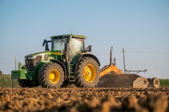 A tractor plowing a field with a plow