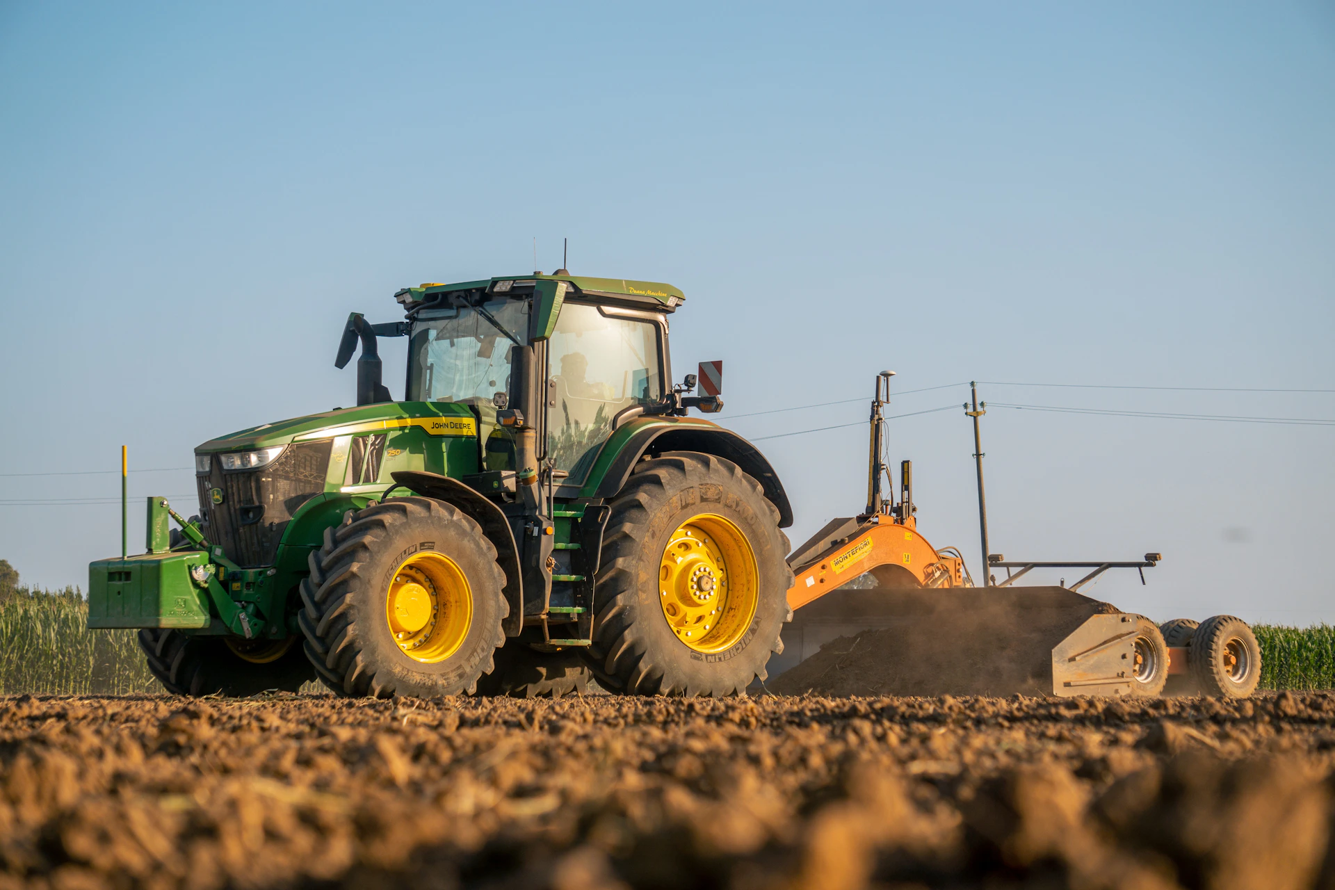 A tractor plowing a field with a plow