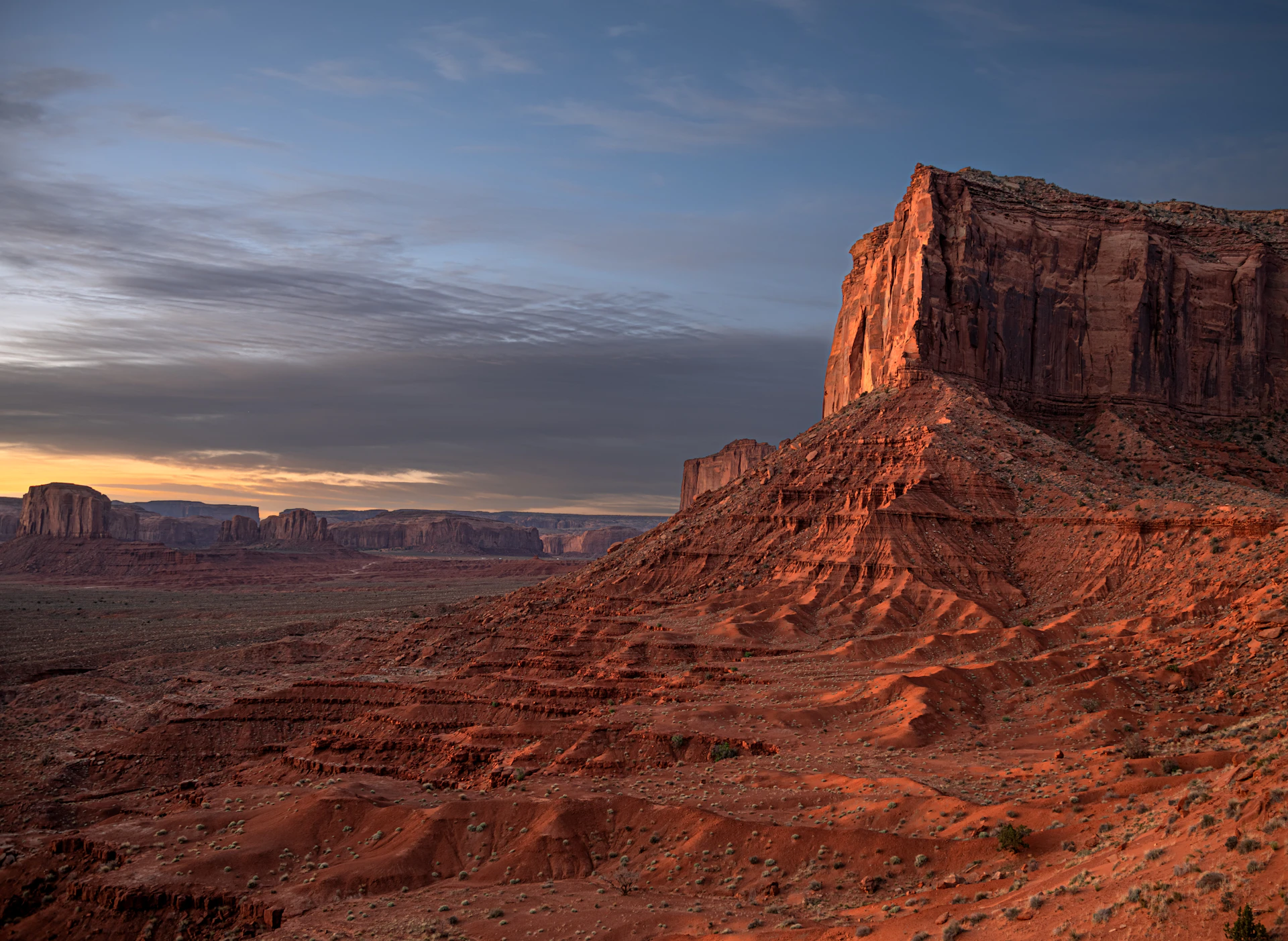 A large rock formation in the middle of a desert