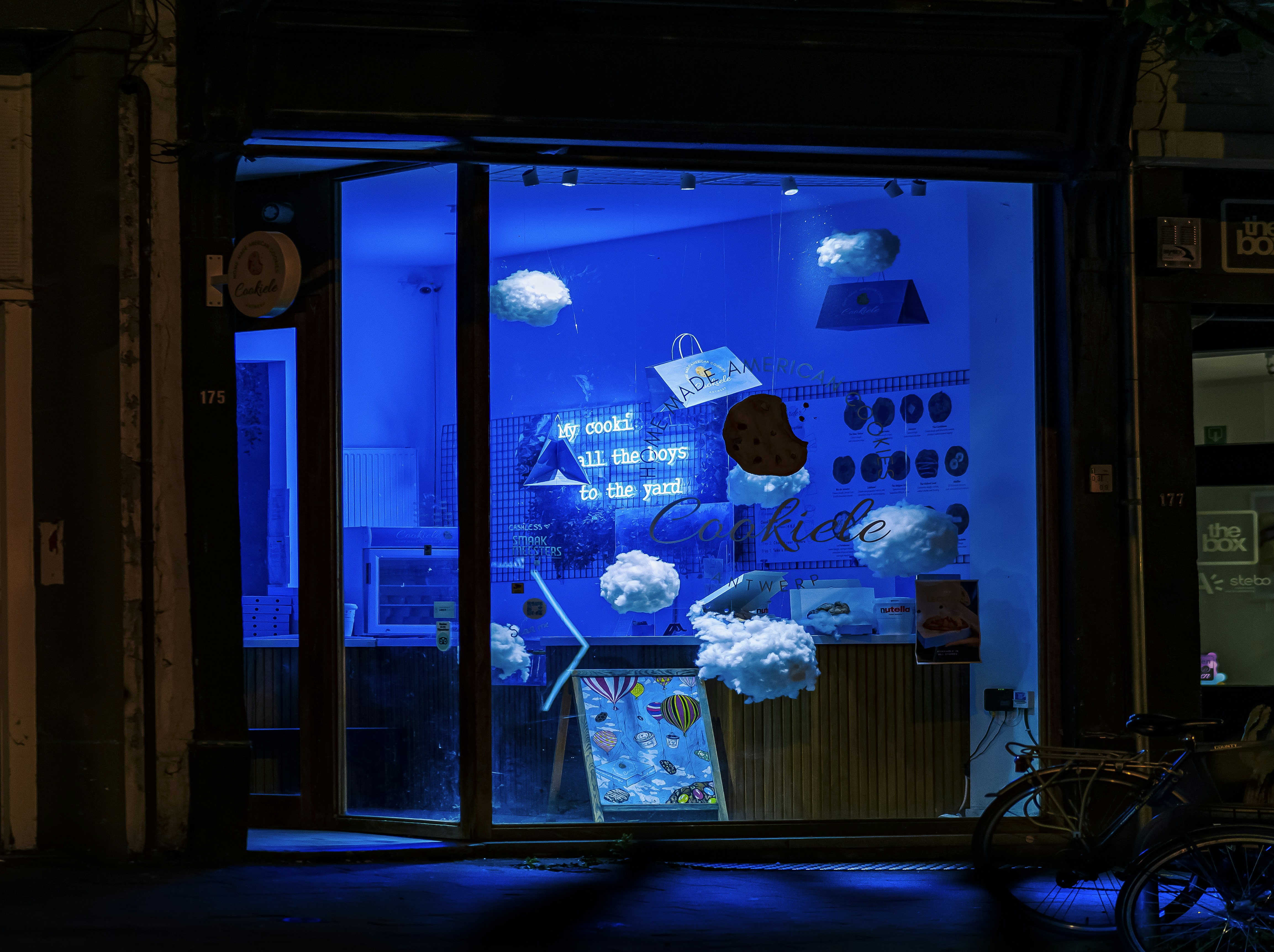 A store front with a blue light in the window, 
