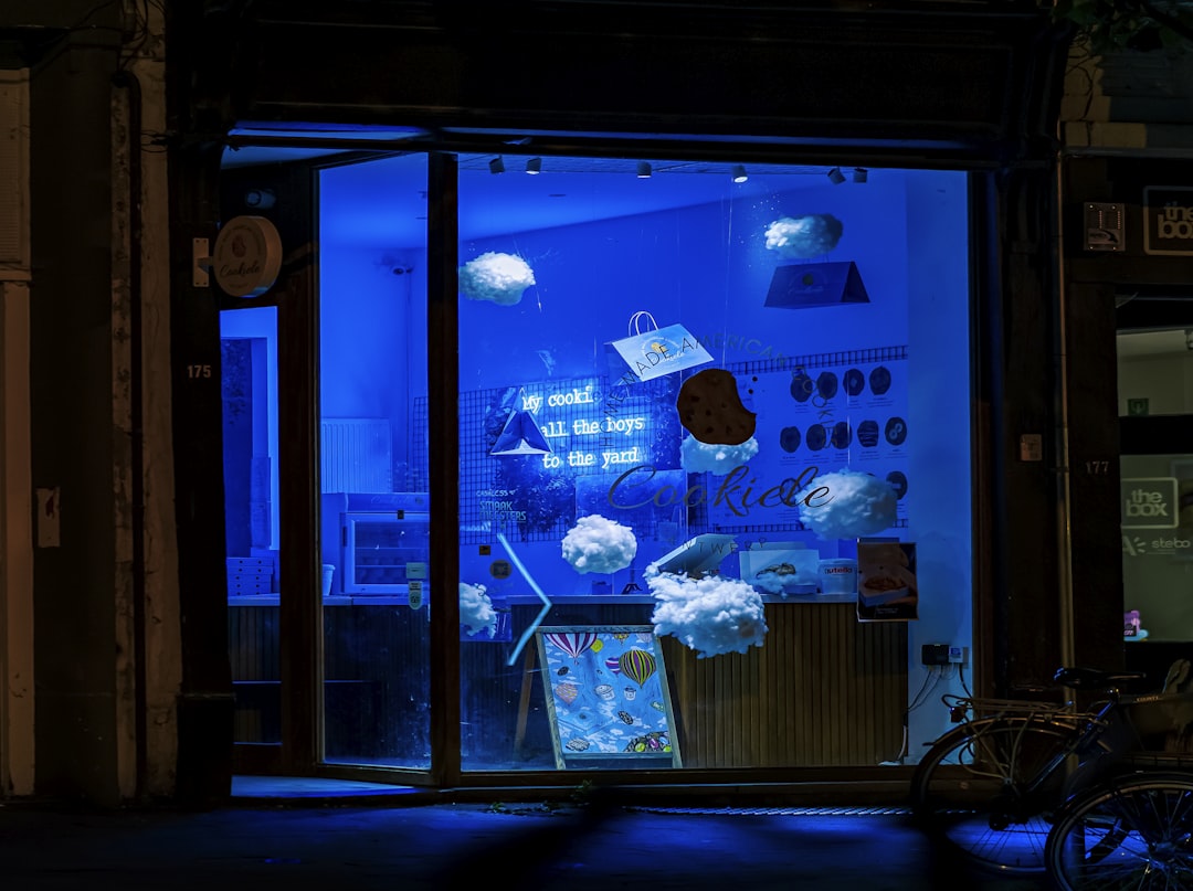 A store front with a blue light in the window,
