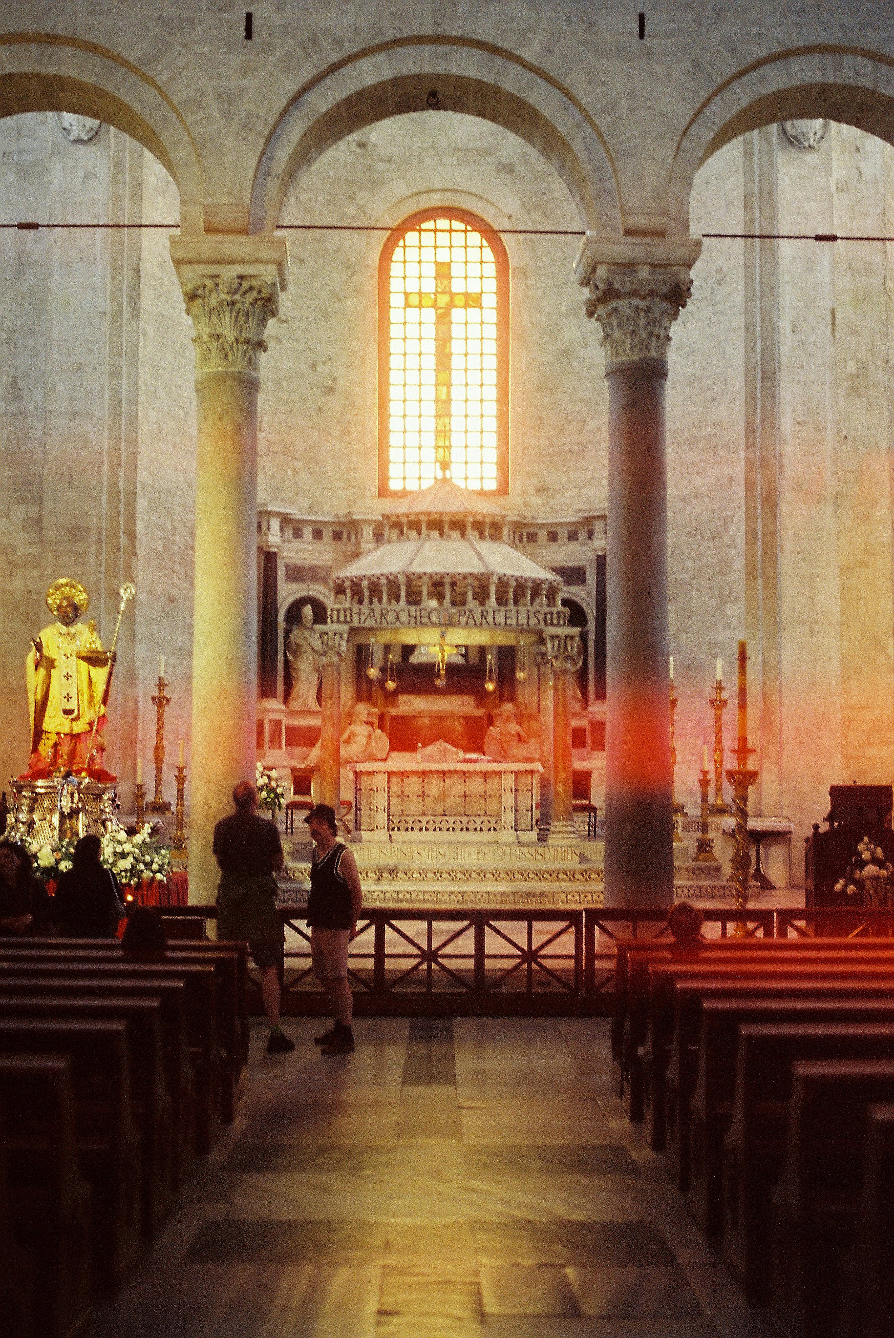 A church filled with pews and a statue