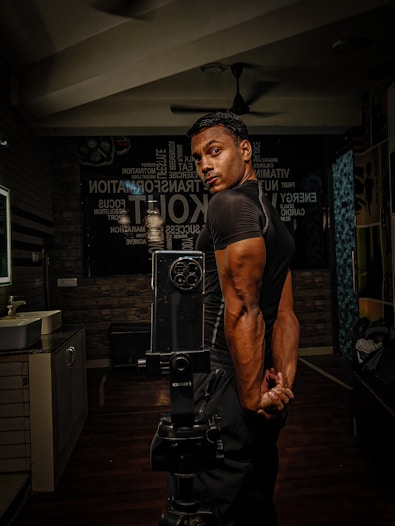 A man standing in a room with a camera