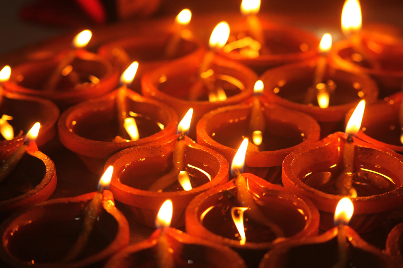 Rows of traditional diyas glowing during Diwali