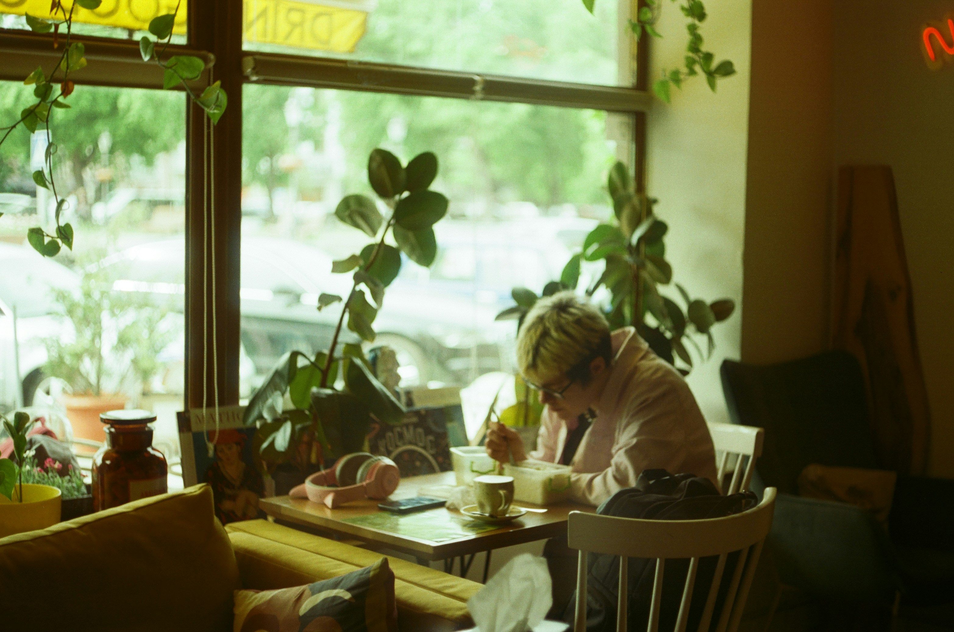 small business owner working on laptop in cozy cafe