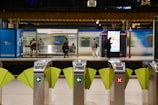 A train station with a row of green and white paper cranes