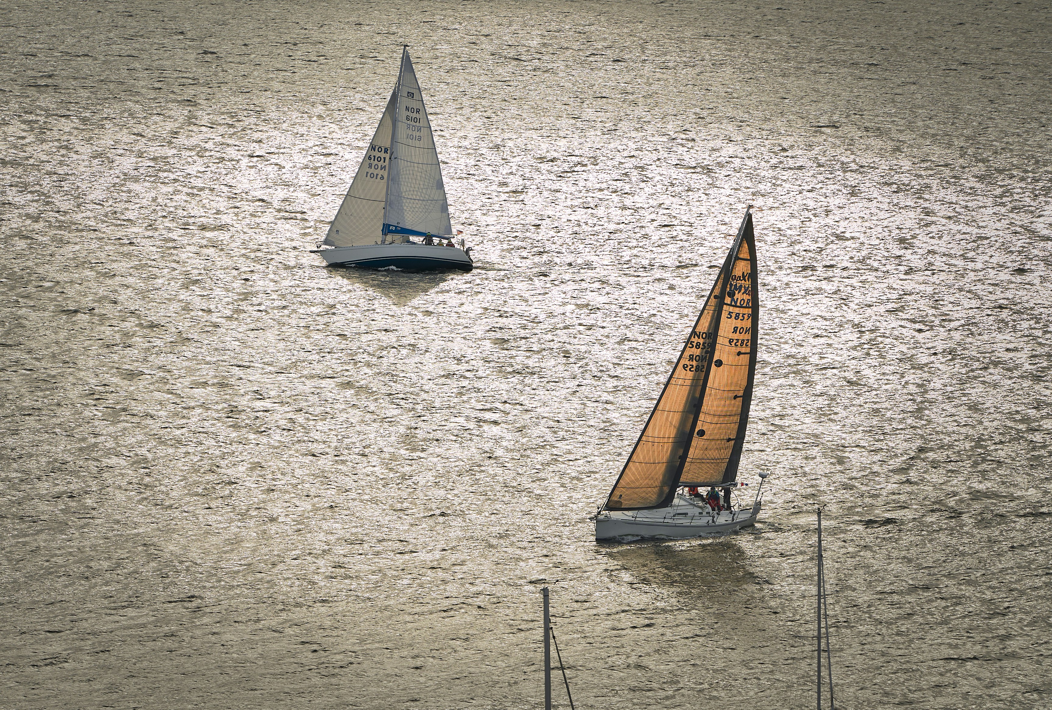 A couple of boats floating on top of a lake