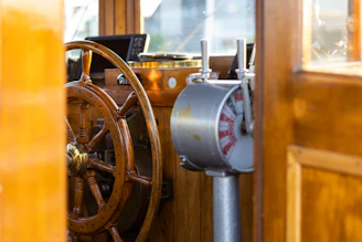 A steering wheel on a wooden boat