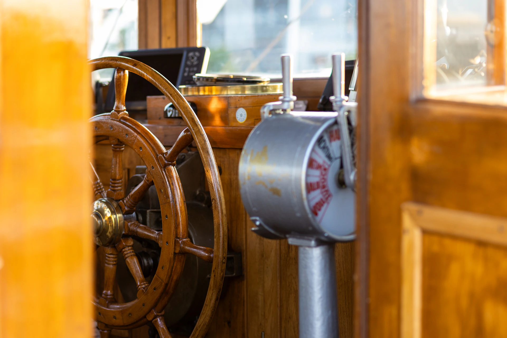 A steering wheel on a wooden boat