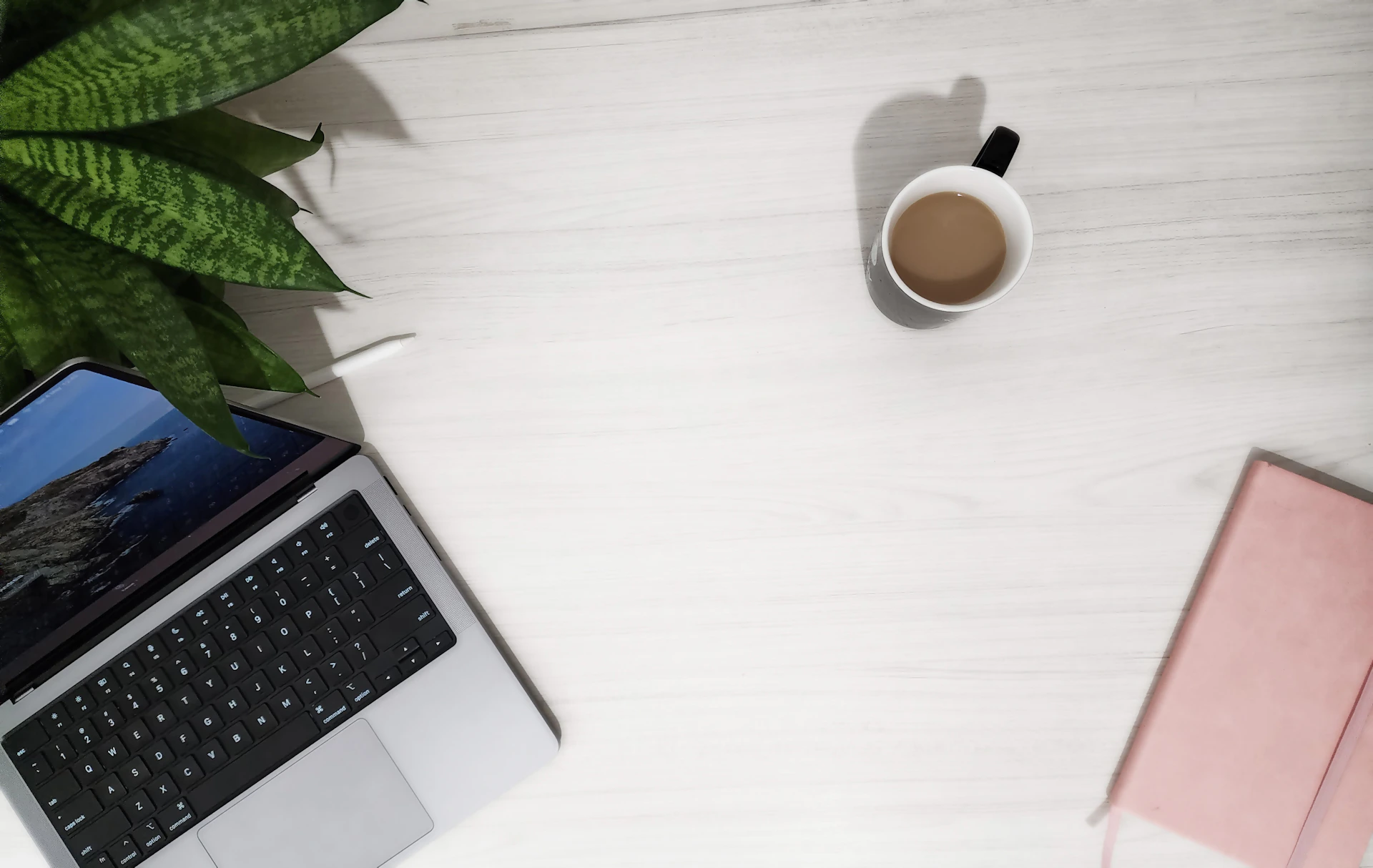 A laptop computer sitting on top of a white desk