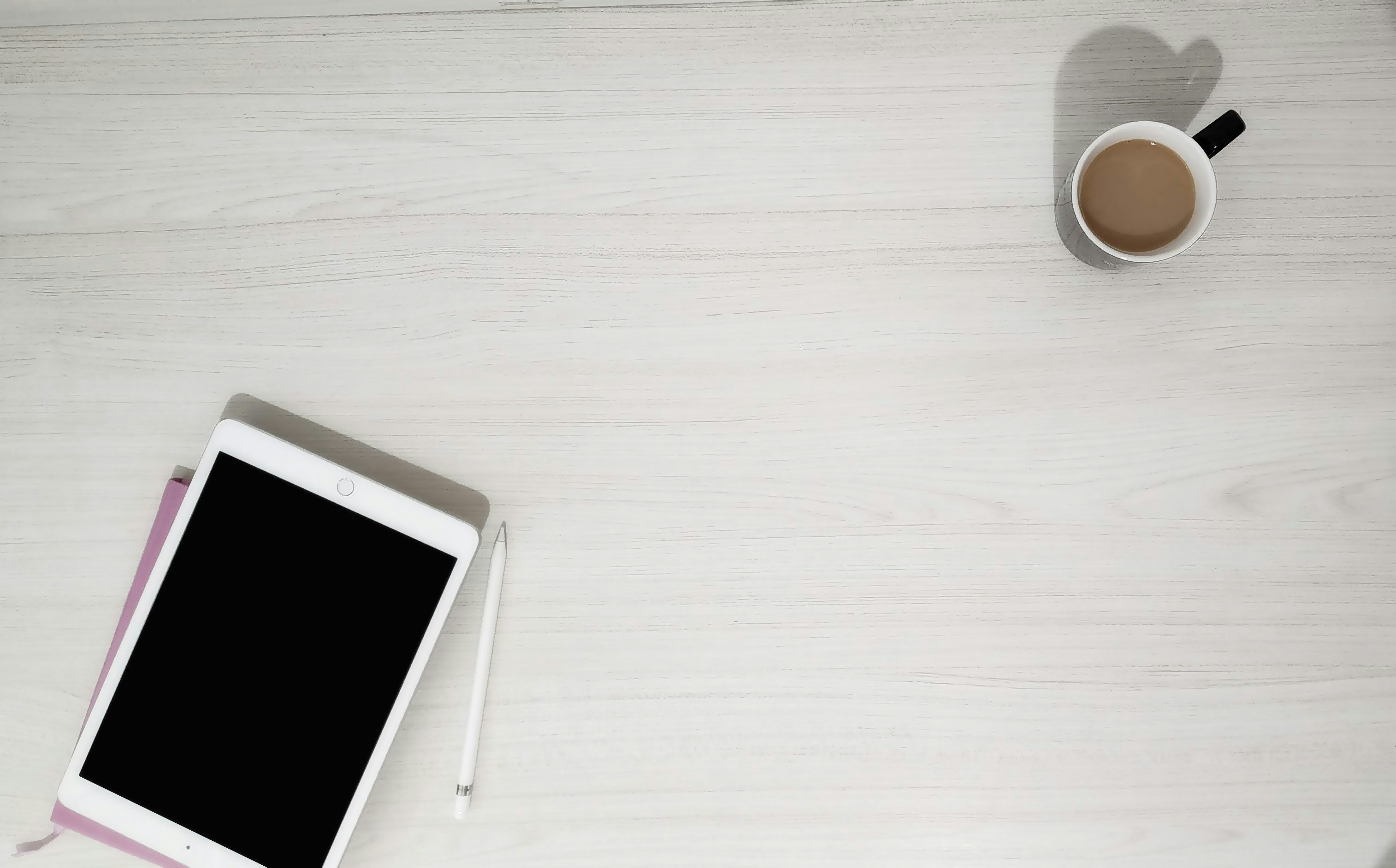 modern home office desk with tablet computer and coffee cup