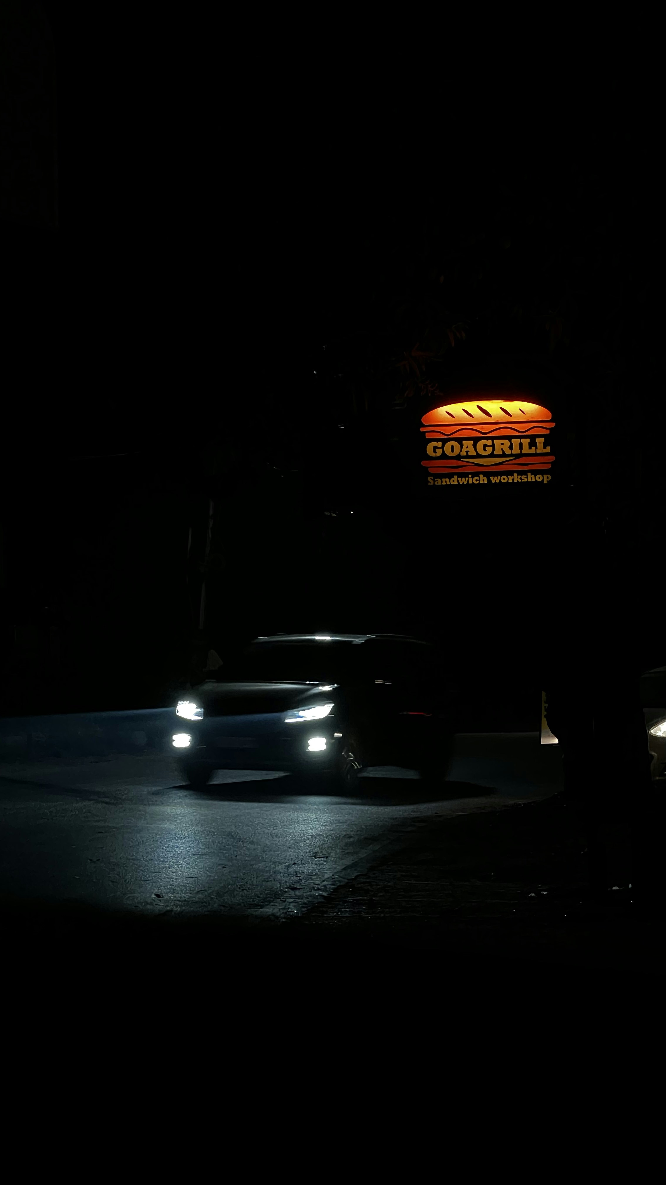 A car driving down a street at night