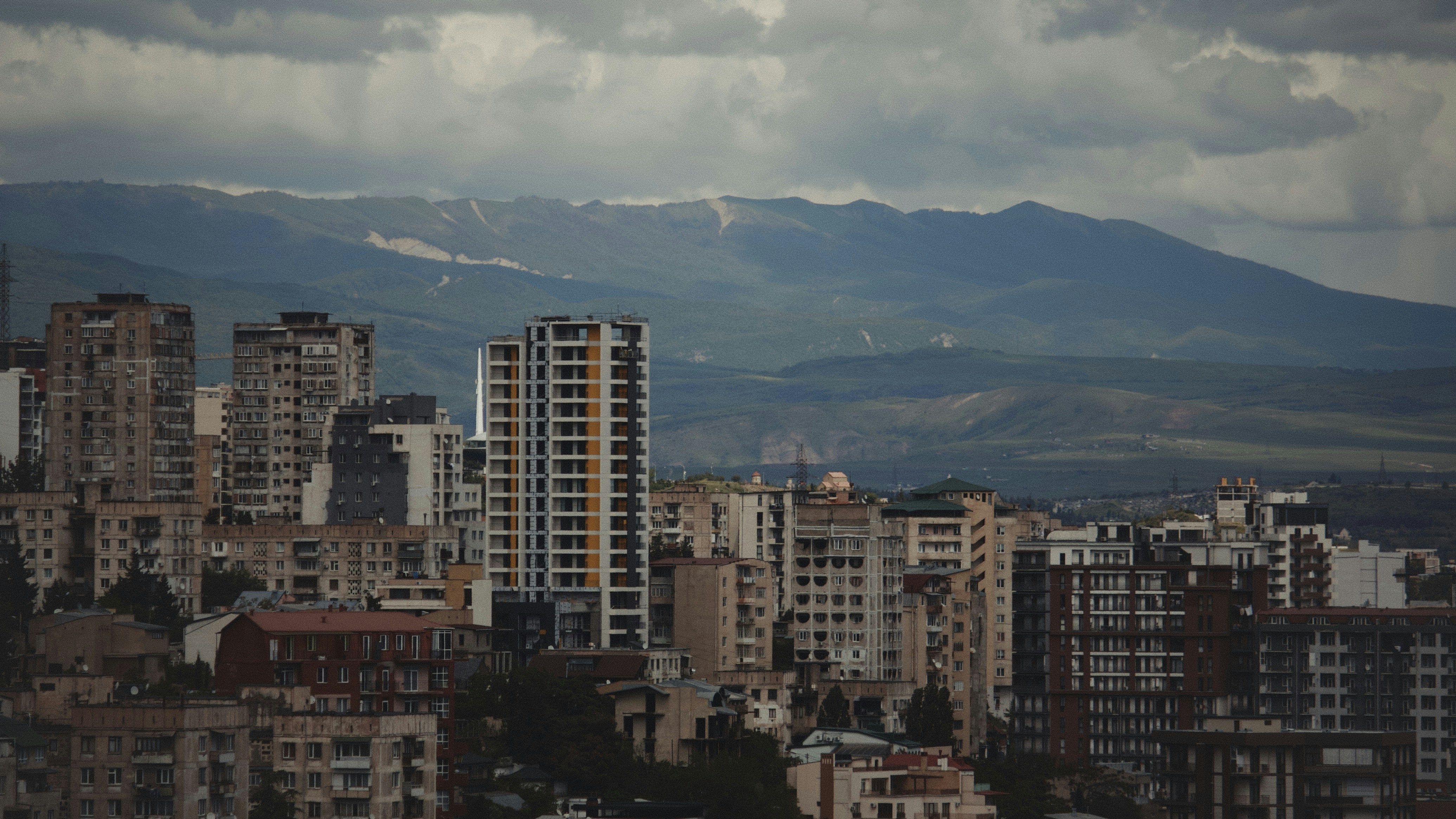 A view of a city with mountains in the background