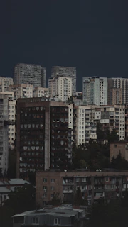 A view of a Tbilisi with old Soviet style buildings under a dark sky