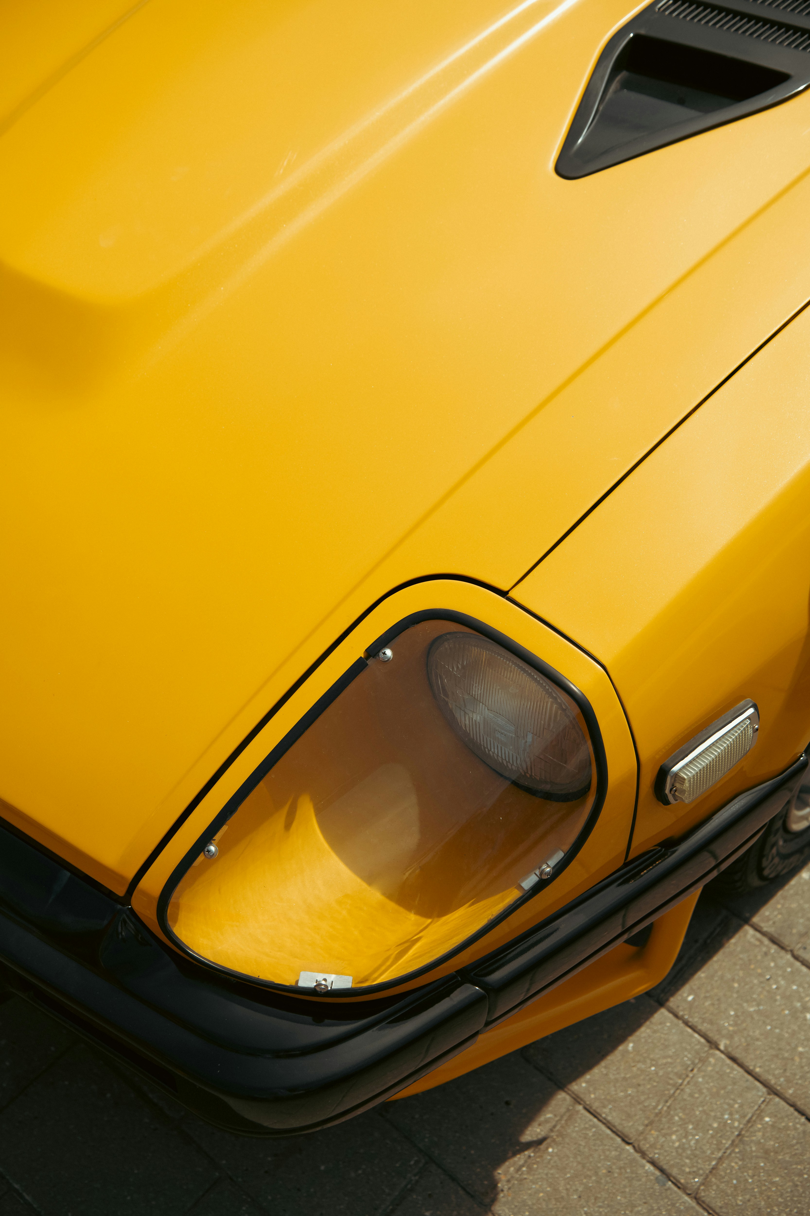A yellow sports car parked on the side of the roadby Sergey Sokolov