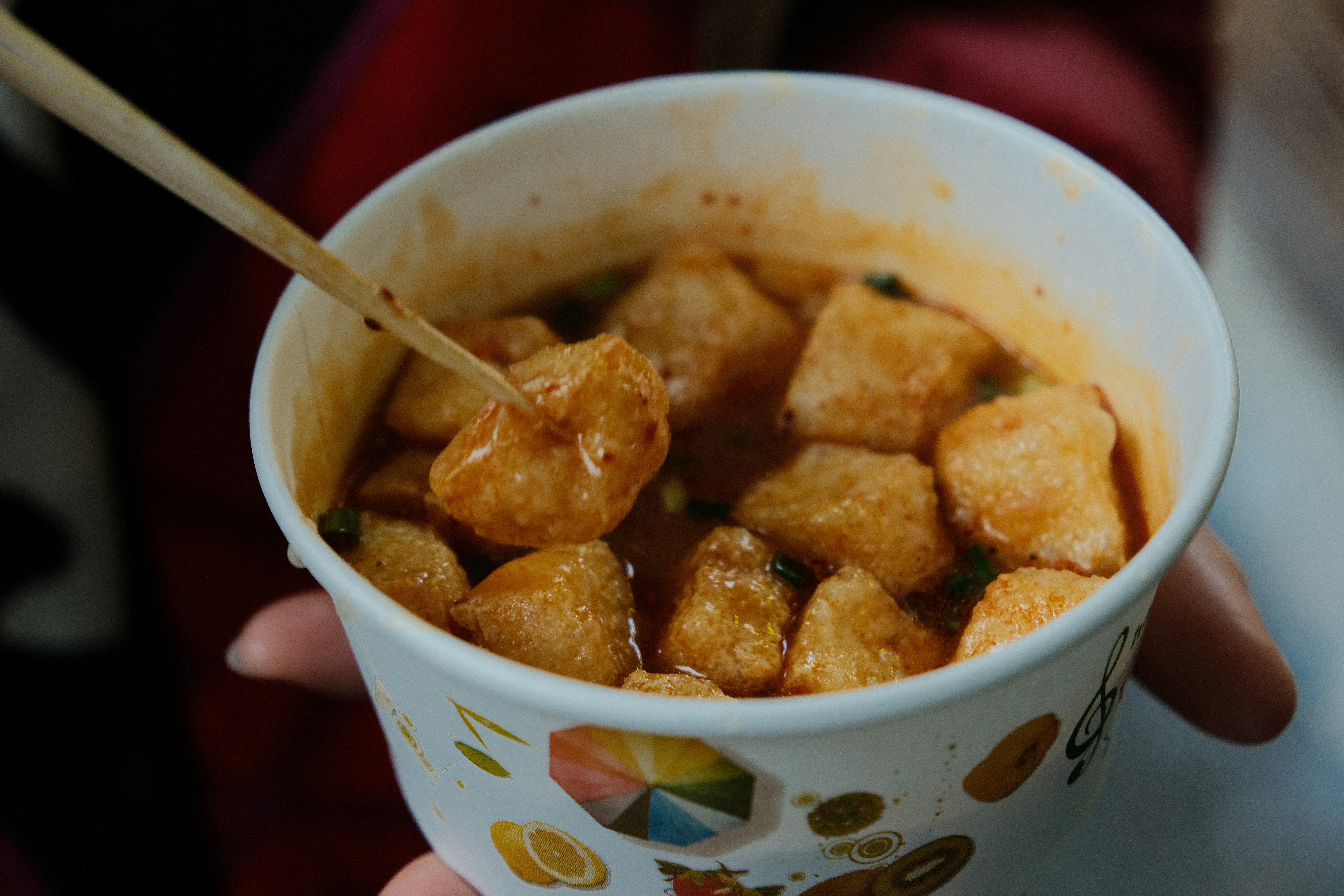 Cup of fried rice cakes on a skewer