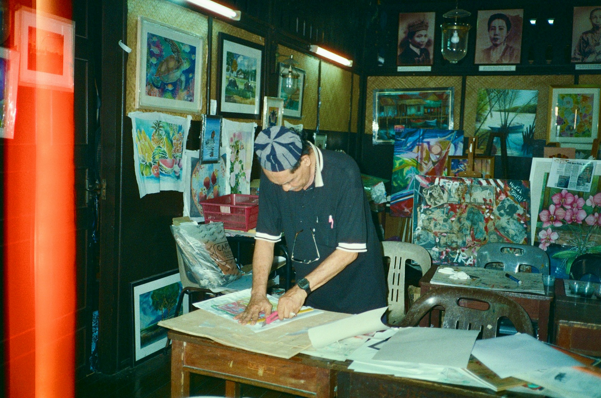 a man working on a piece of art in a room
